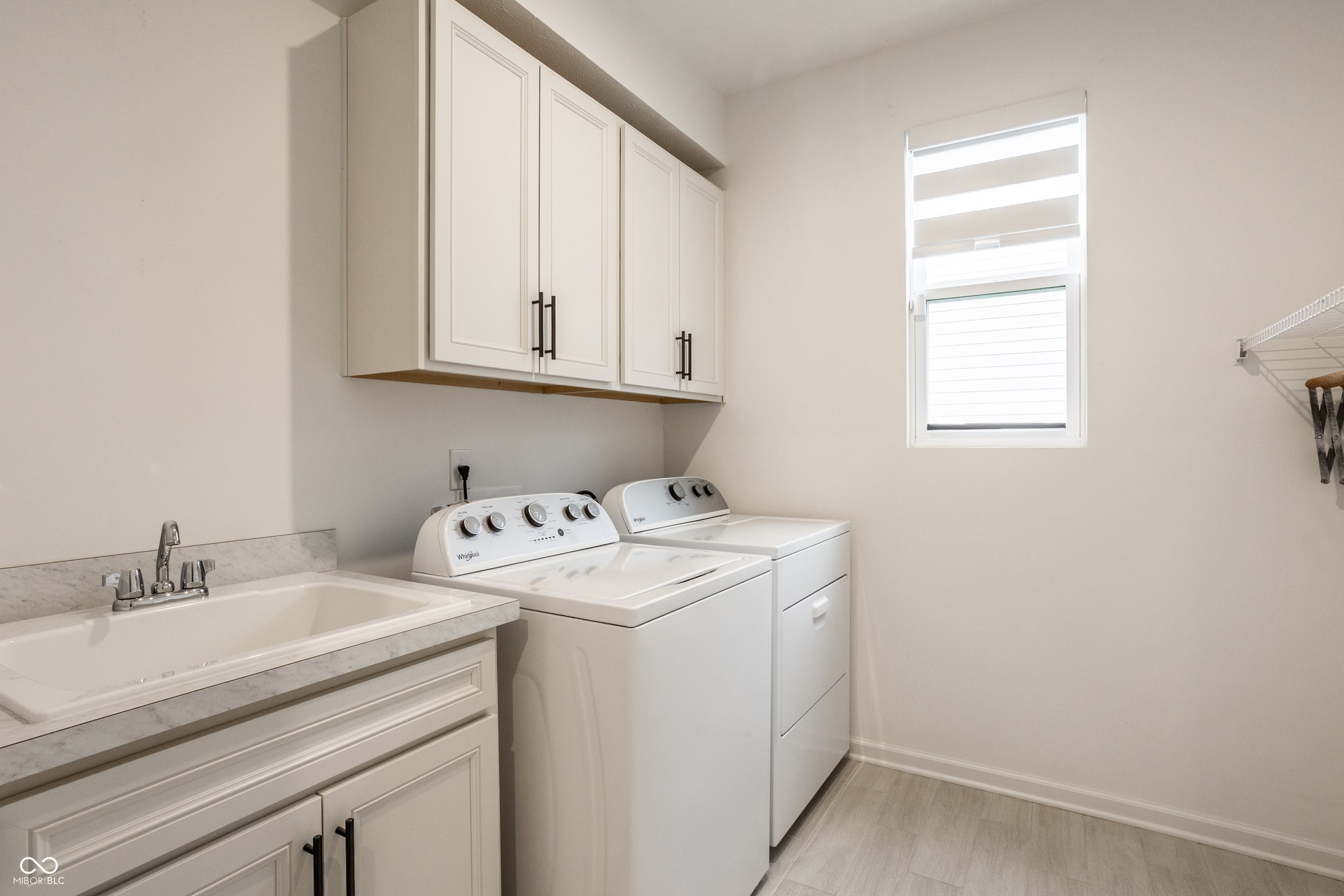 Large laundry room with Whirlpool washer & dryer