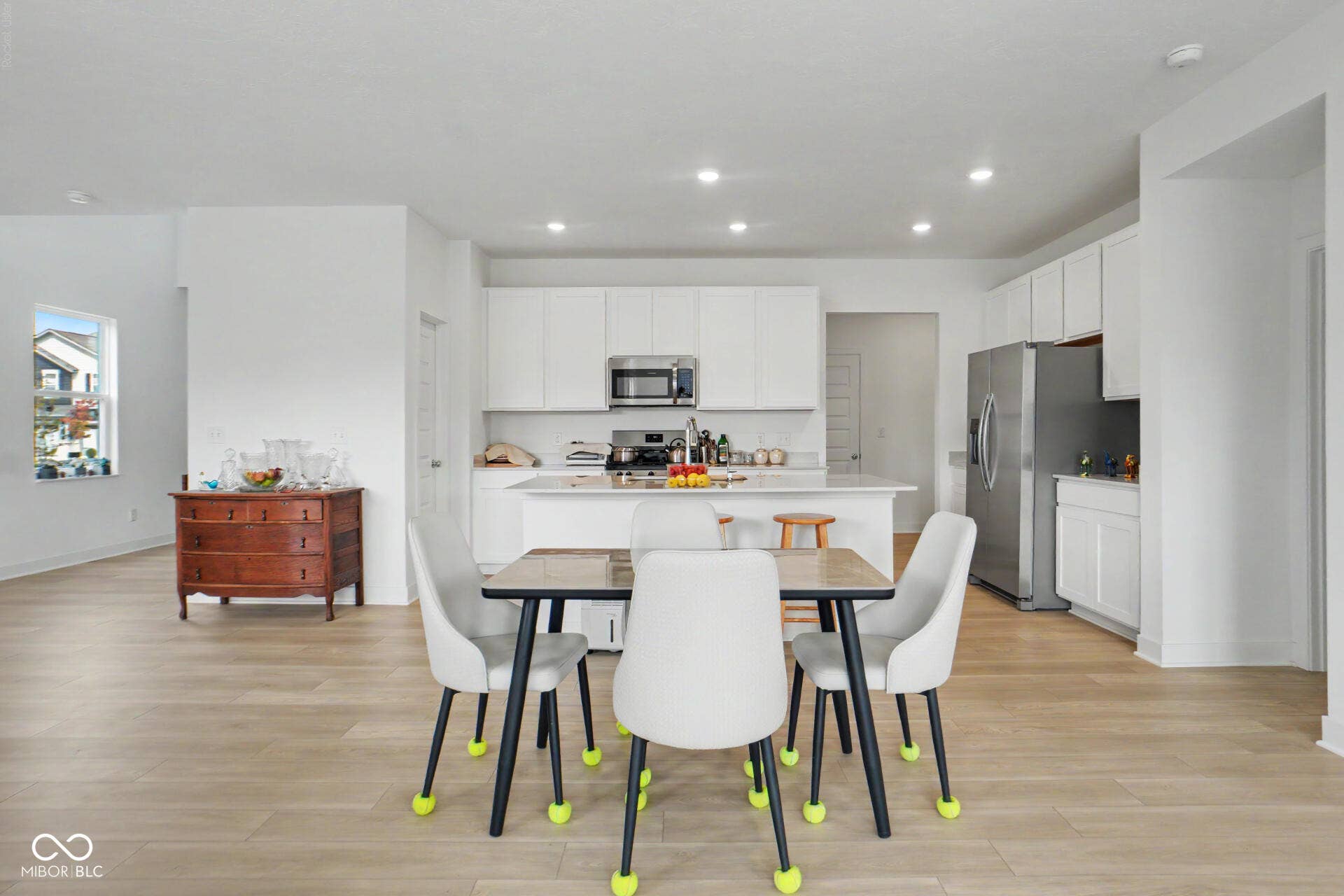 4357 Red Pine Drive, Bargersville, IN 46106 Open-concept living space with light wood-finish flooring, recessed lighting, white cabinetry, a kitchen island, and stainless steel appliances