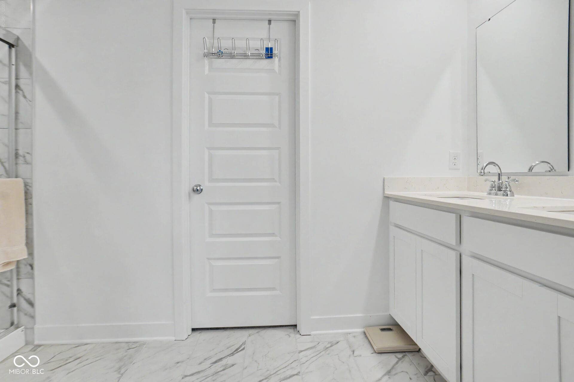 4357 Red Pine Drive, Bargersville, IN 46106 Dual basin vanity with white cabinetry and light-toned countertop, complemented by a large wall mirror and polished chrome fixtures