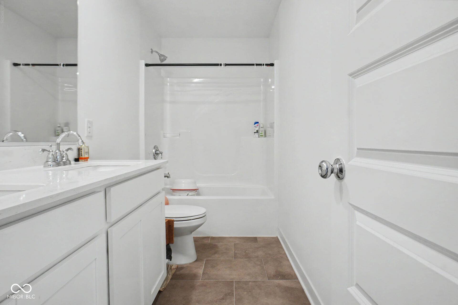 4357 Red Pine Drive, Bargersville, IN 46106 Modern bathroom featuring a spacious vanity with dual sink basin and ample countertop storage, crisp white cabinetry, and a frameless glass-enclosed shower with polished chrome fixtures