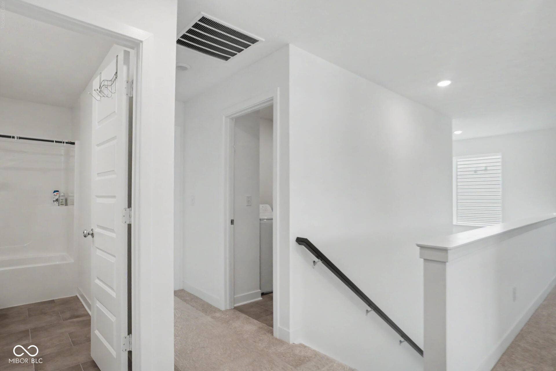 4357 Red Pine Drive, Bargersville, IN 46106 Recessed lighting throughout, white interior walls, white paneled doors, carpeted hallway, black metal handrail