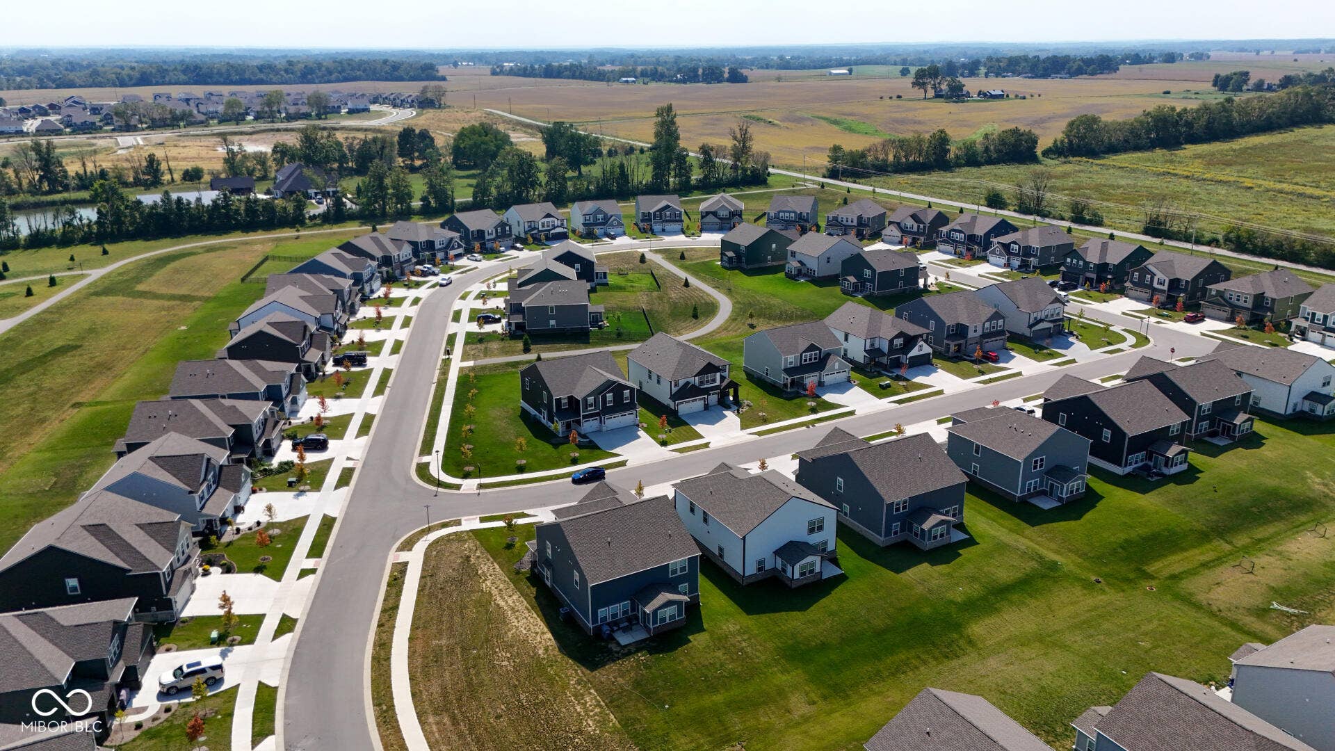 4357 Red Pine Drive, Bargersville, IN 46106 Contemporary residential development featuring a curved street design, individual driveways, mature landscaping, and uniform rooflines