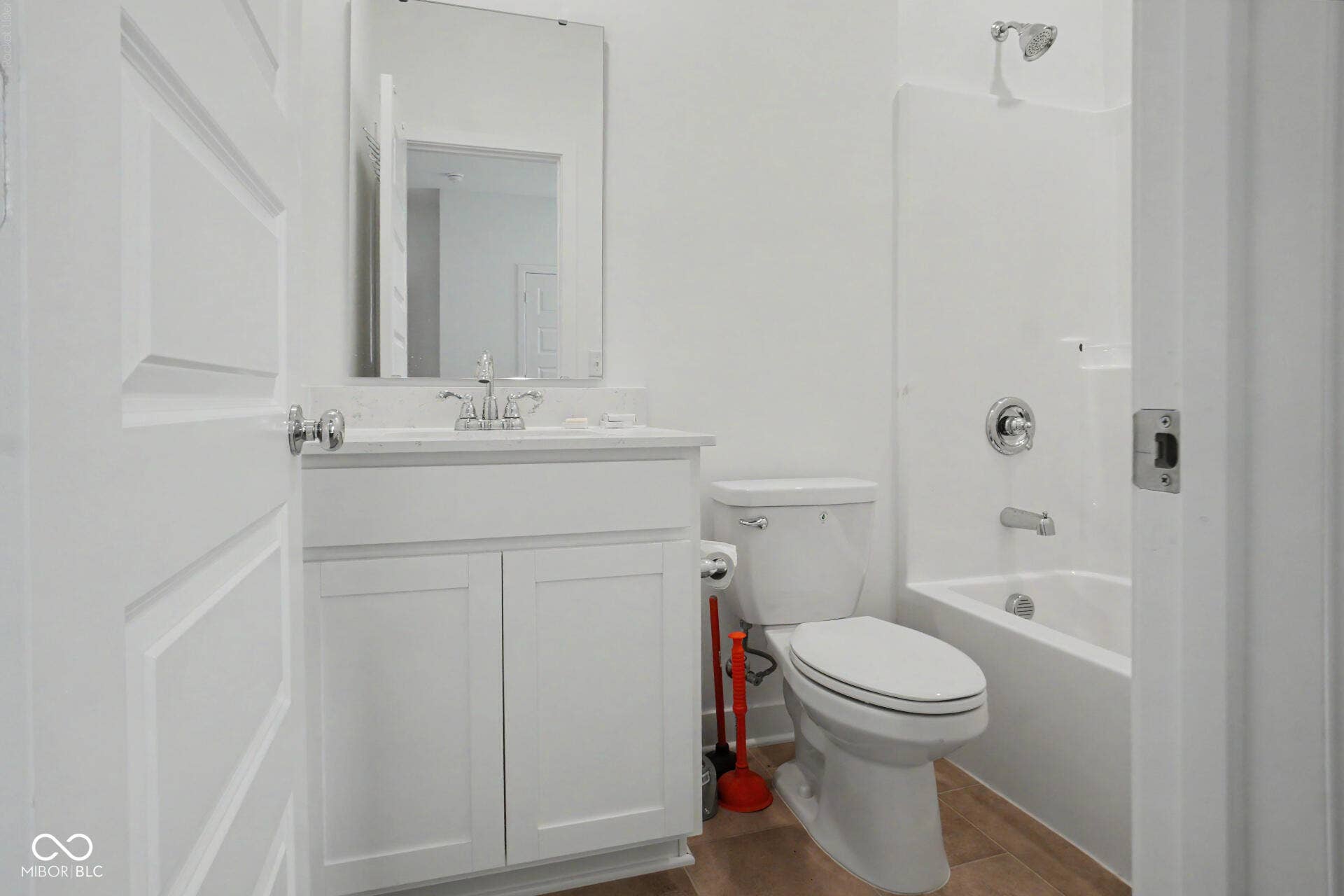 4357 Red Pine Drive, Bargersville, IN 46106 White single vanity with chrome faucet, a rectangular wall-mounted mirror, a white toilet, and a white tub with chrome fixtures