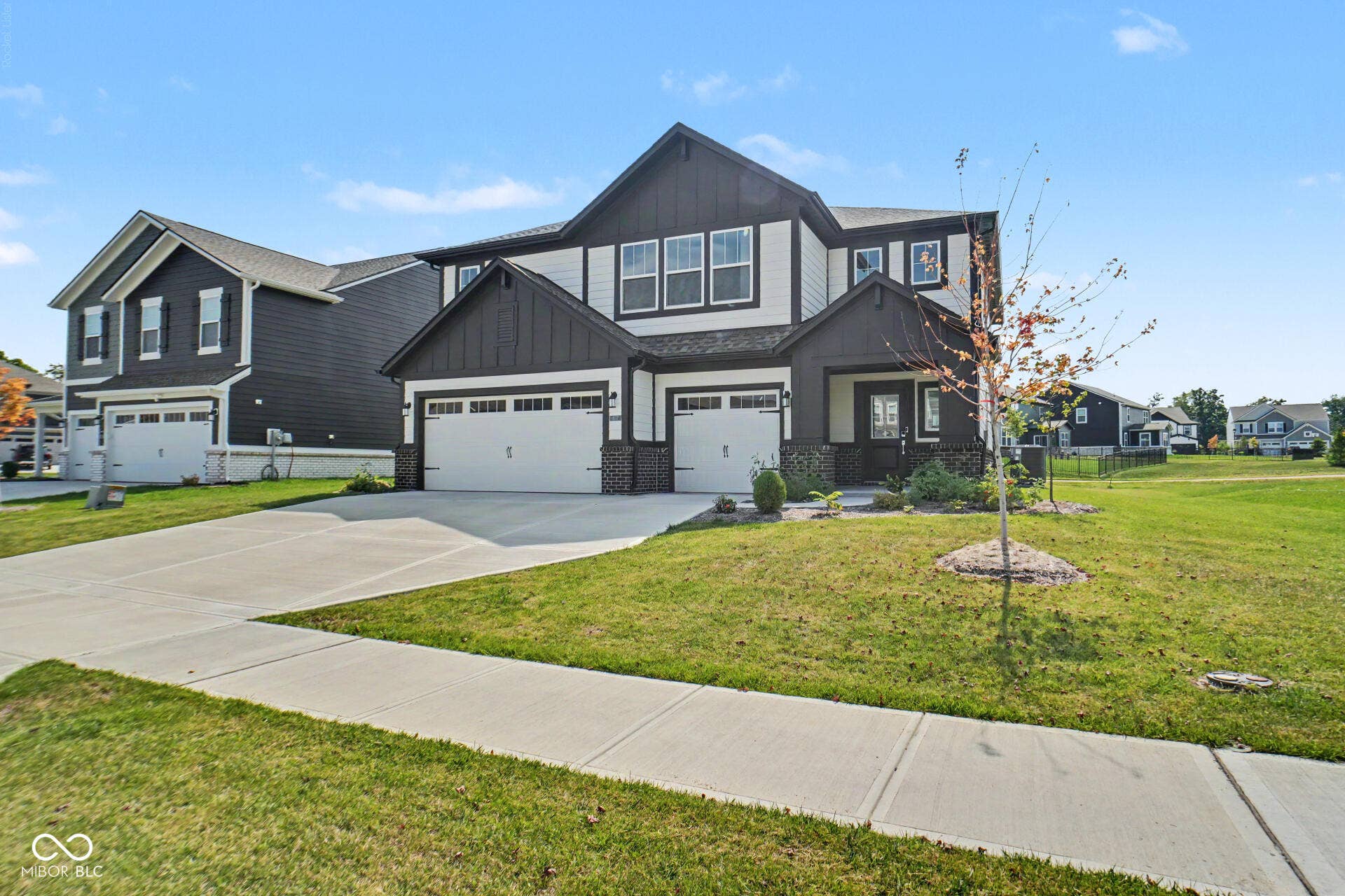 4357 Red Pine Drive, Bargersville, IN 46106 Two-story exterior with dark siding and white trim, featuring a two-car garage, covered entry, and concrete driveway