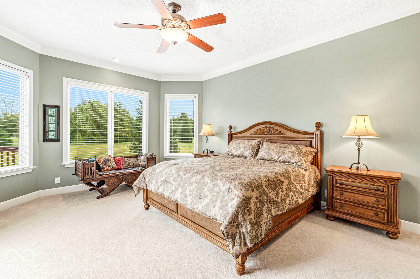 Carpeted flooring, crown molding, and a ceiling fan with integrated lighting