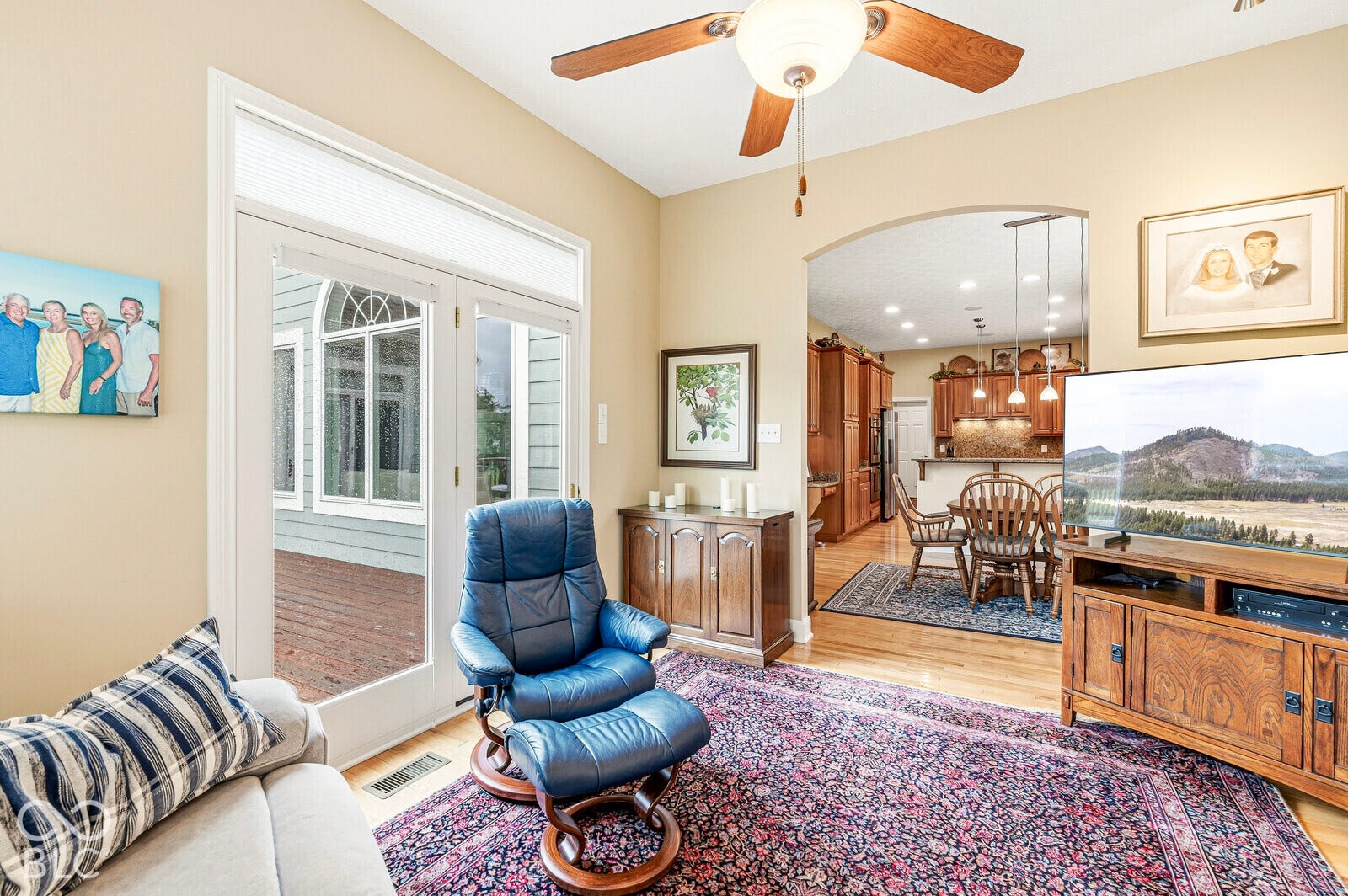 Vaulted ceiling with ceiling fan, French doors with transom window, hardwood flooring, arched entryway, recessed lighting
