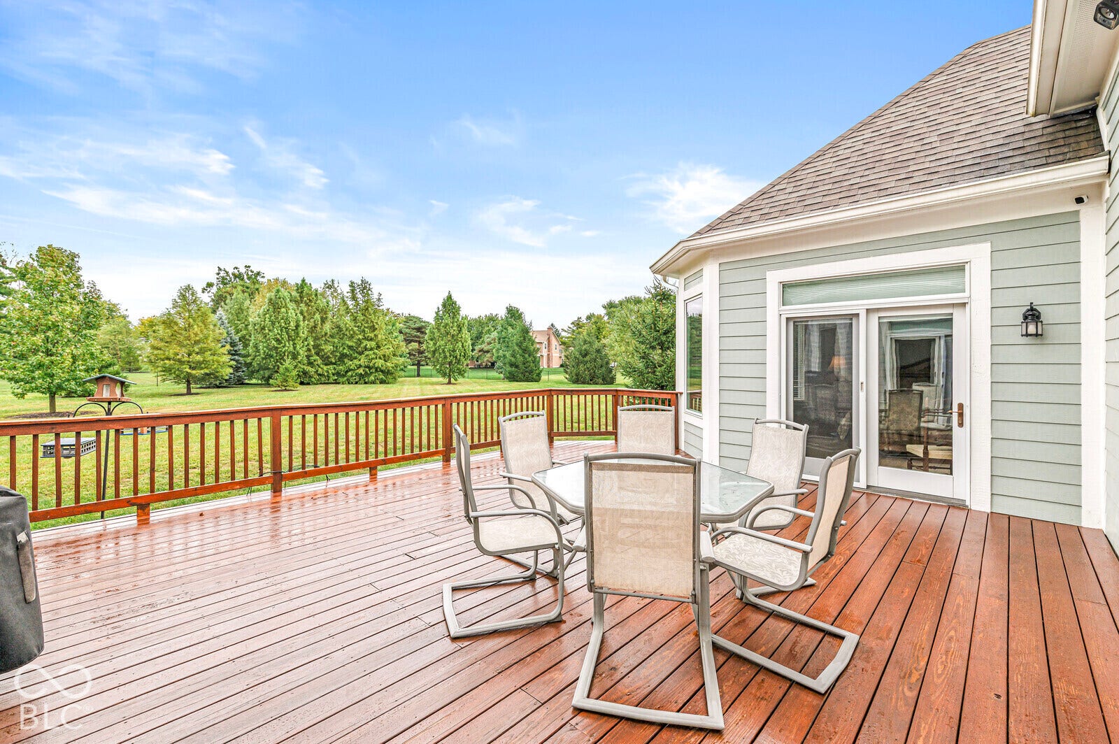 Expansive wood deck with a full-height railing
