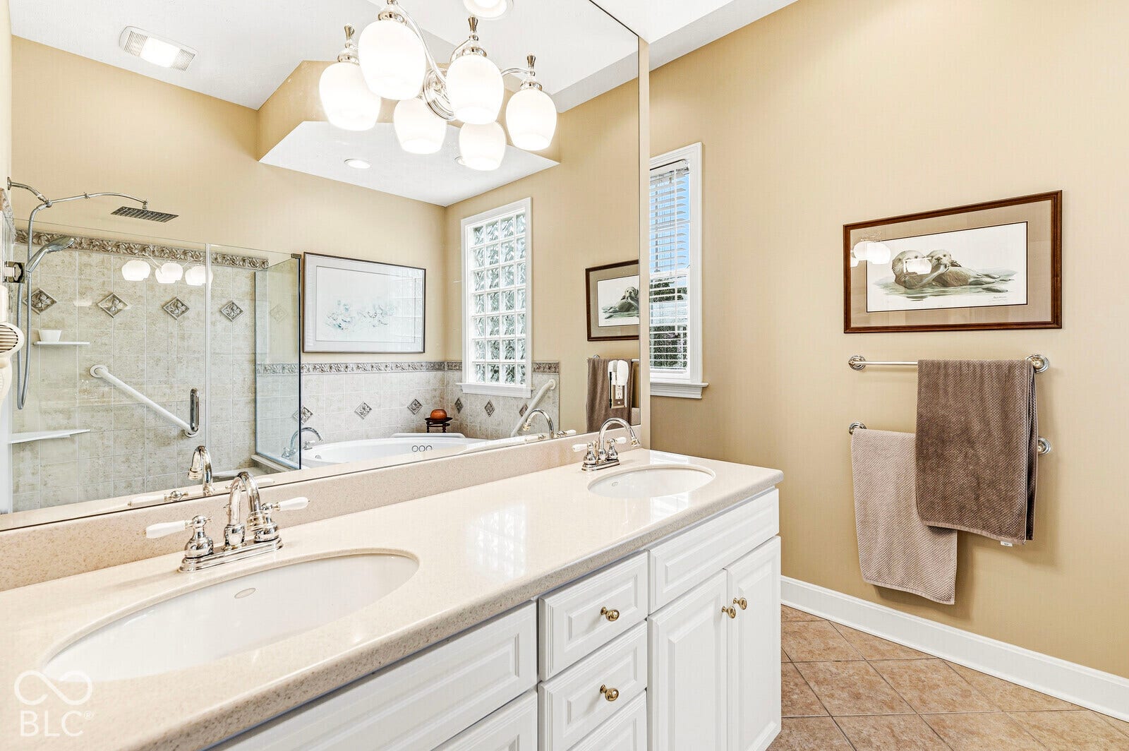 Dual vanity with undermount sinks, white cabinetry, and a light-toned countertop