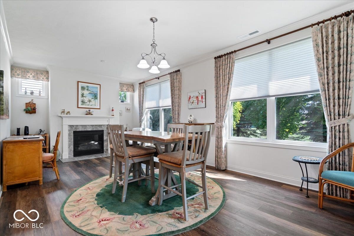 At the back of the home is the hearth room and nook, brimming with natural light looking over the private backyard