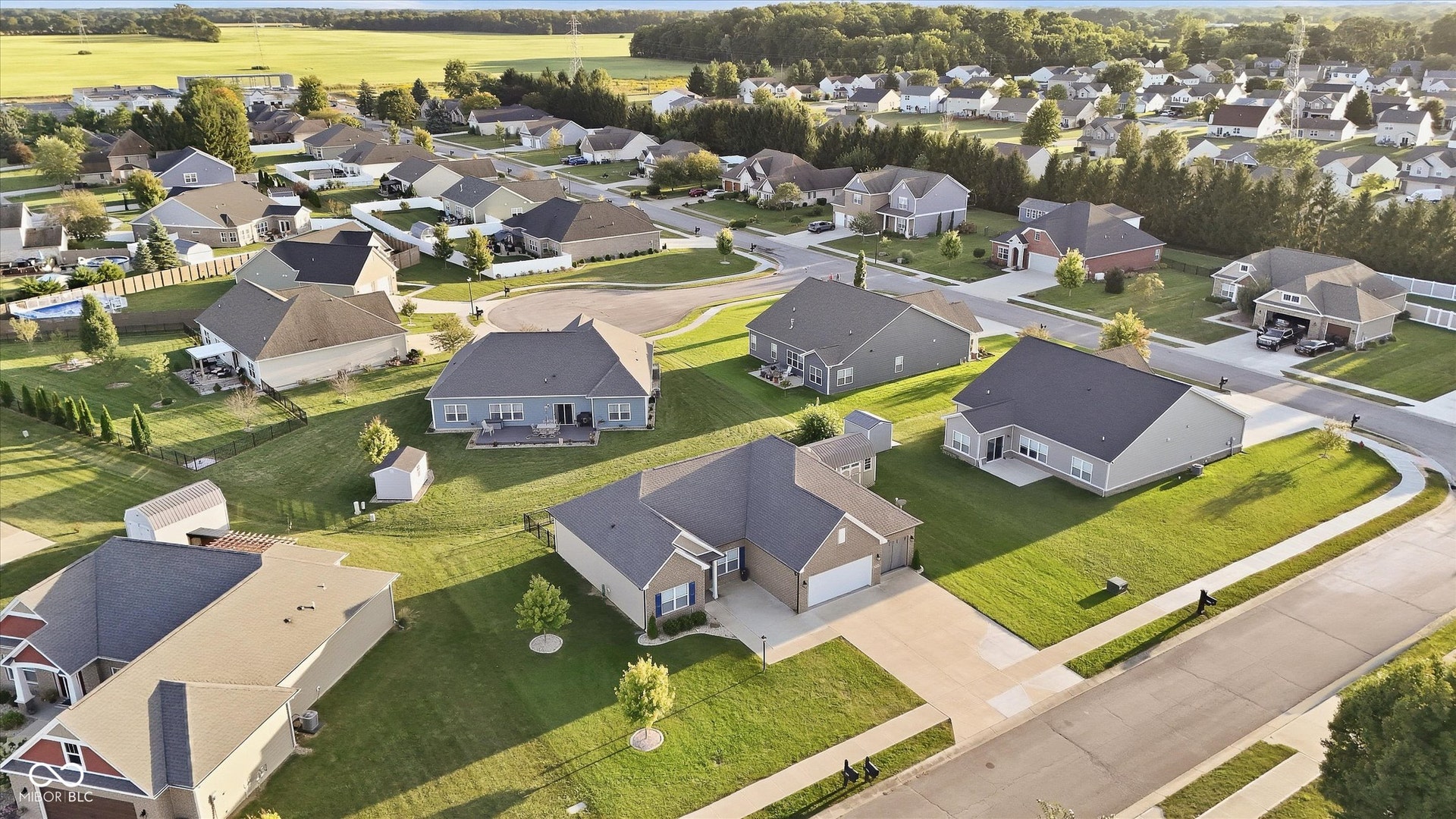 Suburban residential neighborhood featuring single-family homes with pitched roofs and attached garages
