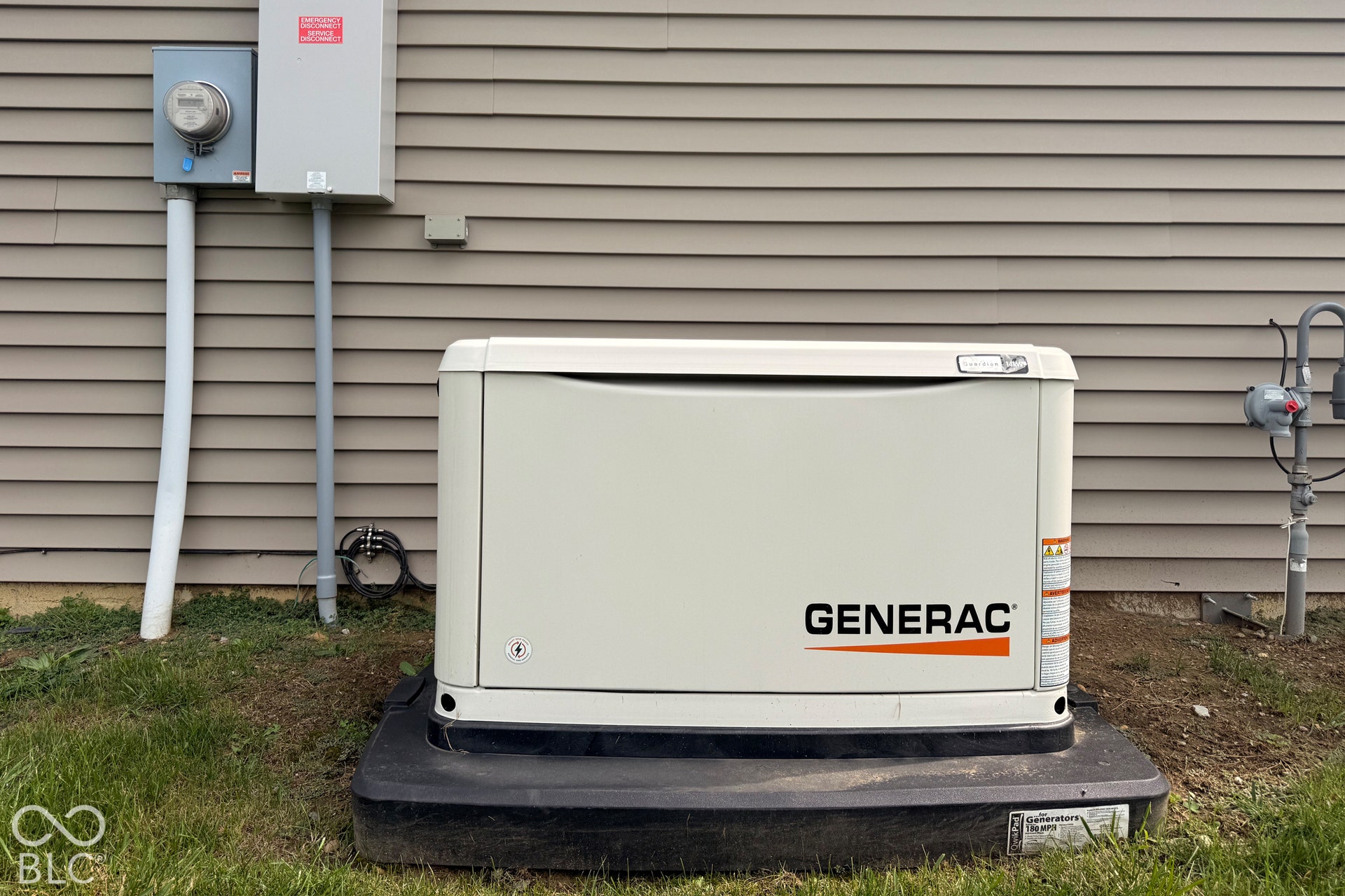 Whole-home generator, electrical meter, utility boxes, and gas line connections