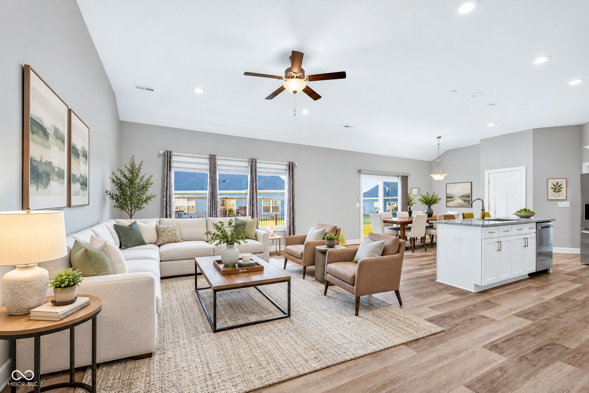 Virtually Altered - Open-concept living area with vaulted ceilings, recessed lighting, and wood-finish flooring