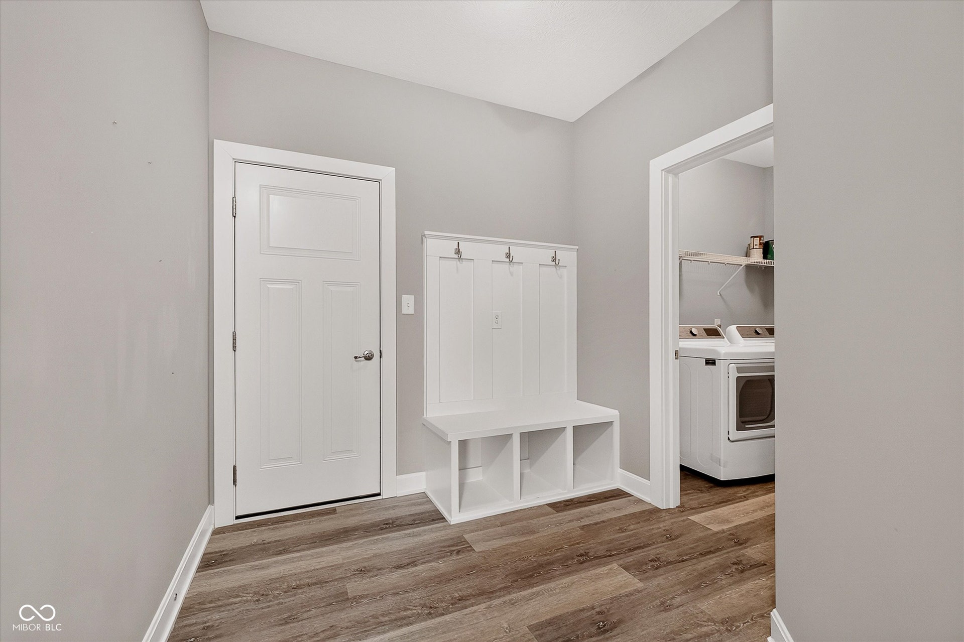 Wood-finish flooring throughout, complemented by light gray walls and white trim