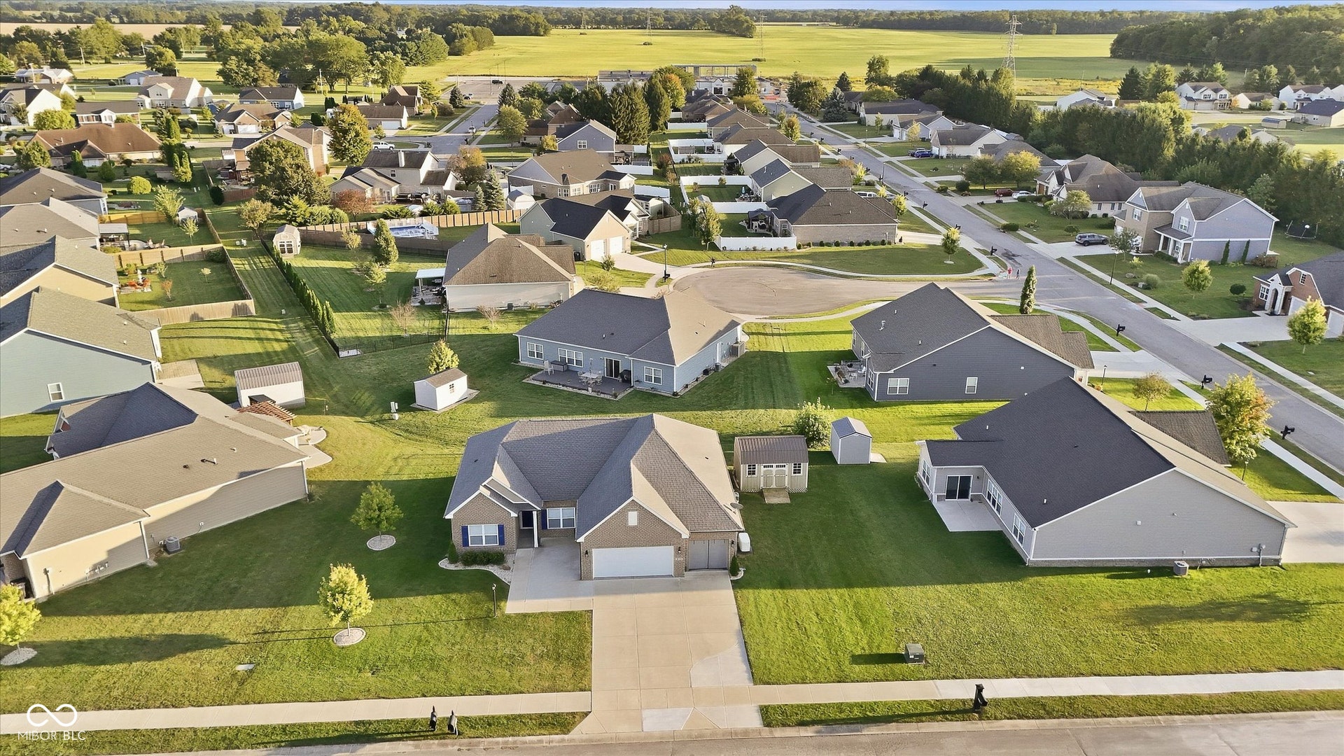 Suburban setting with consistent home styles and well-maintained lawns