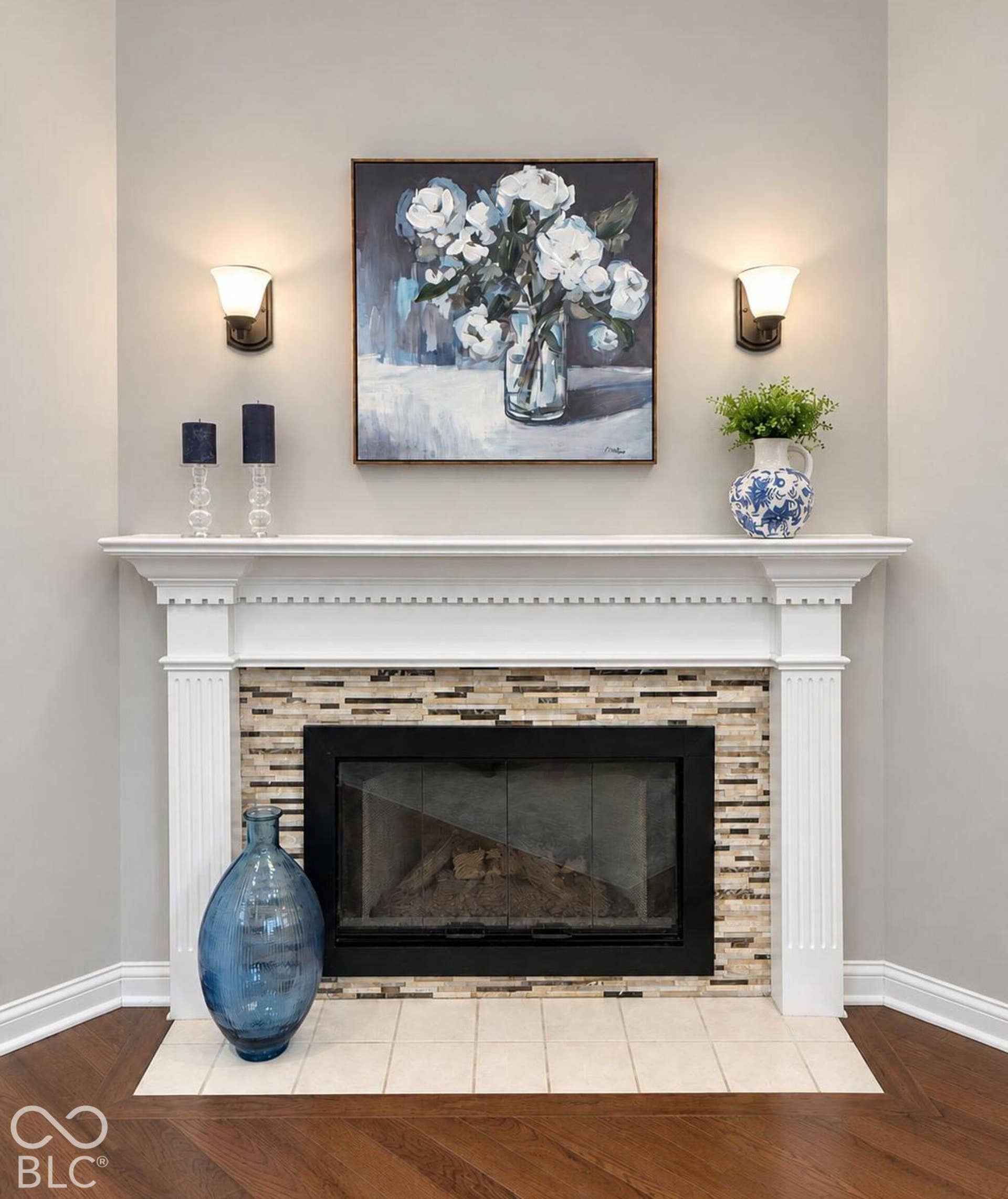 Handsome fireplace with mantel and featuring a mosaic tile surround and a tiled hearth