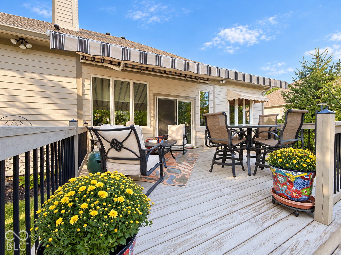Expansive outdoor deck with wood-finish flooring and black spindle railing