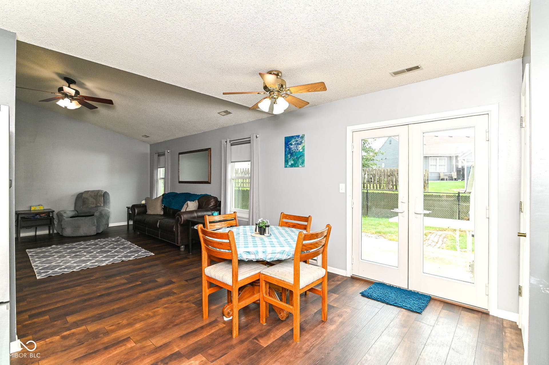Wood-finish flooring throughout, vaulted ceiling, and dual ceiling fans