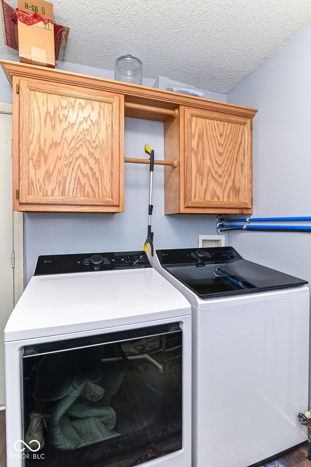 Built-in wood-finish cabinetry featuring a central hanging rod