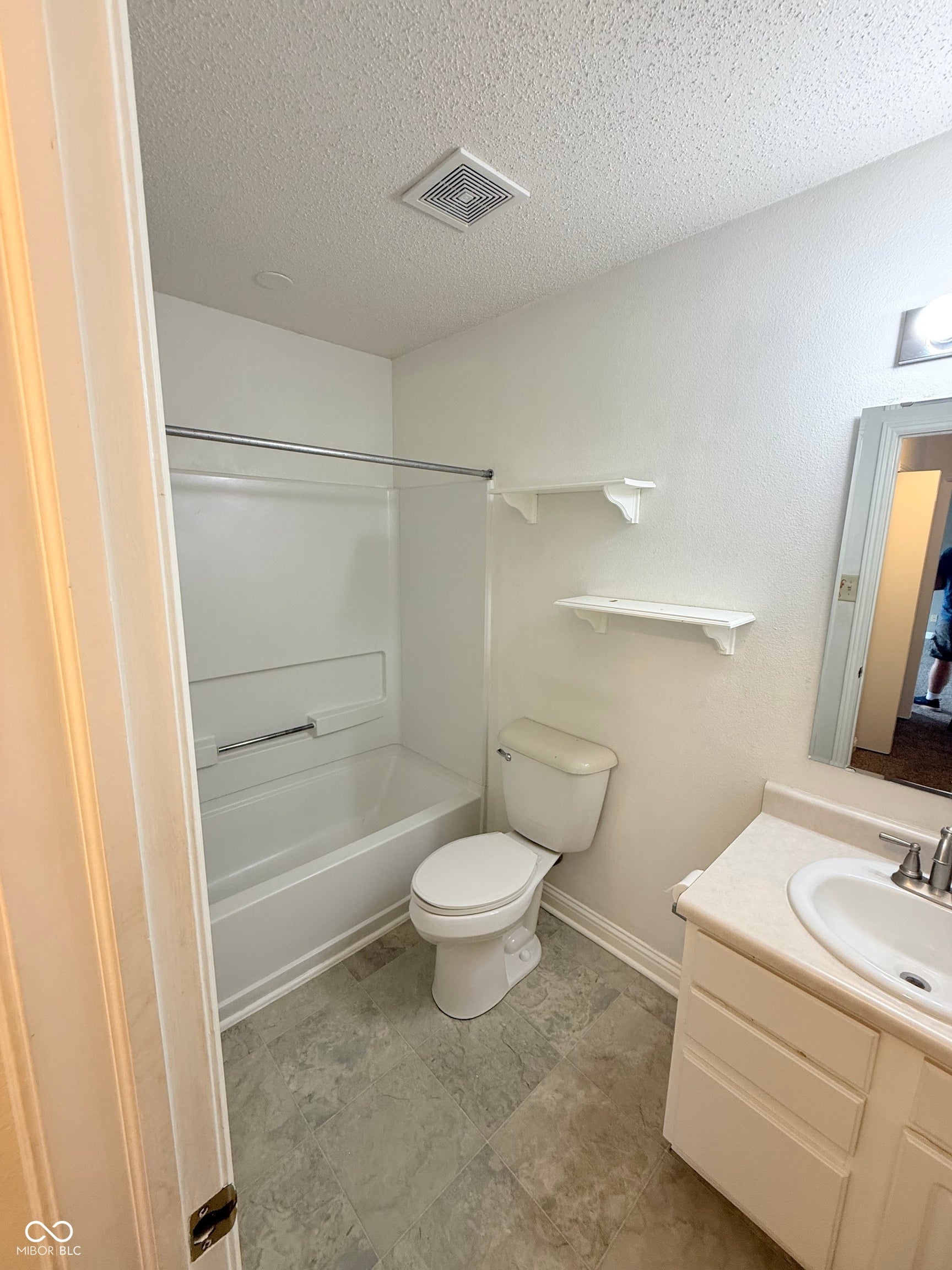 6235 E Mariah Hill Lane, Camby, IN 46113 Bathroom featuring a white tub/shower combination, toilet, and vanity with a built-in sink