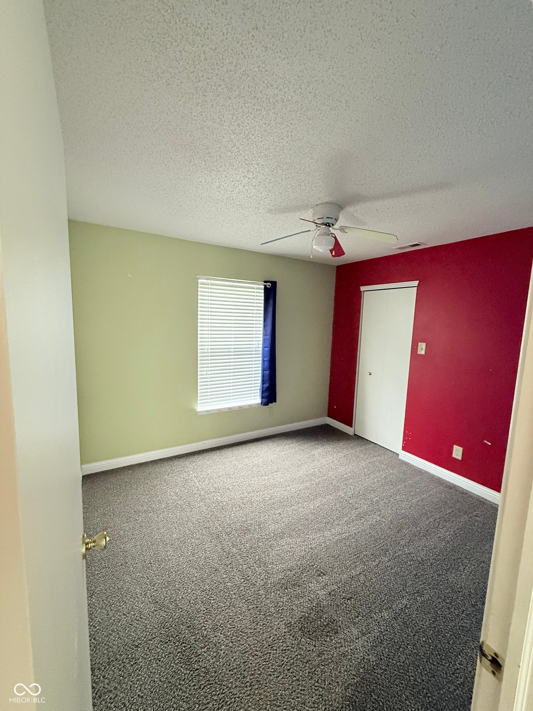 6235 E Mariah Hill Lane, Camby, IN 46113 Neutral-toned carpeting, ceiling fan with light fixture, window with blinds, and a white closet door