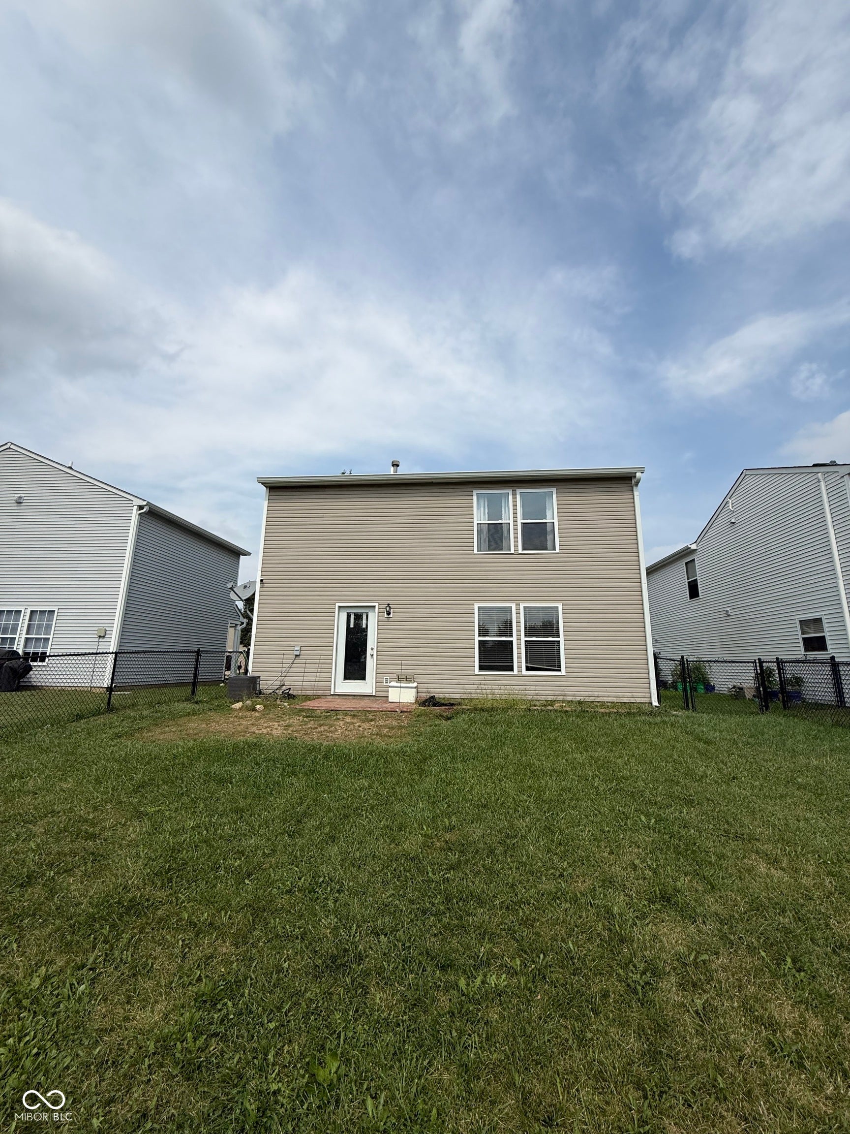 6235 E Mariah Hill Lane, Camby, IN 46113 Rear elevation with neutral-toned siding, multiple windows, and a glass-paneled door