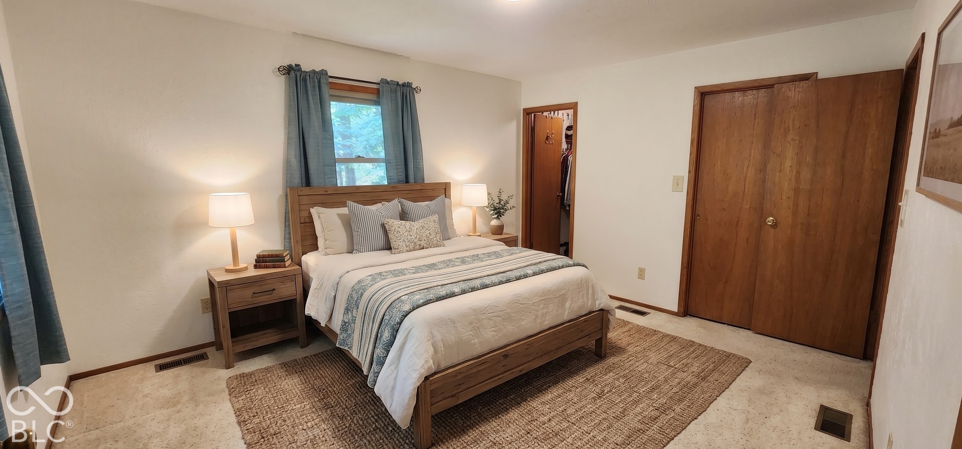 Virtually Altered - Neutral wall color, wood-finish window trim, and a wardrobe closet with wood-finish bi-fold doors
