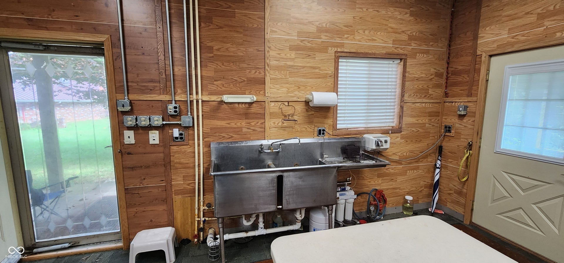 Wood-finish paneling with exposed conduit