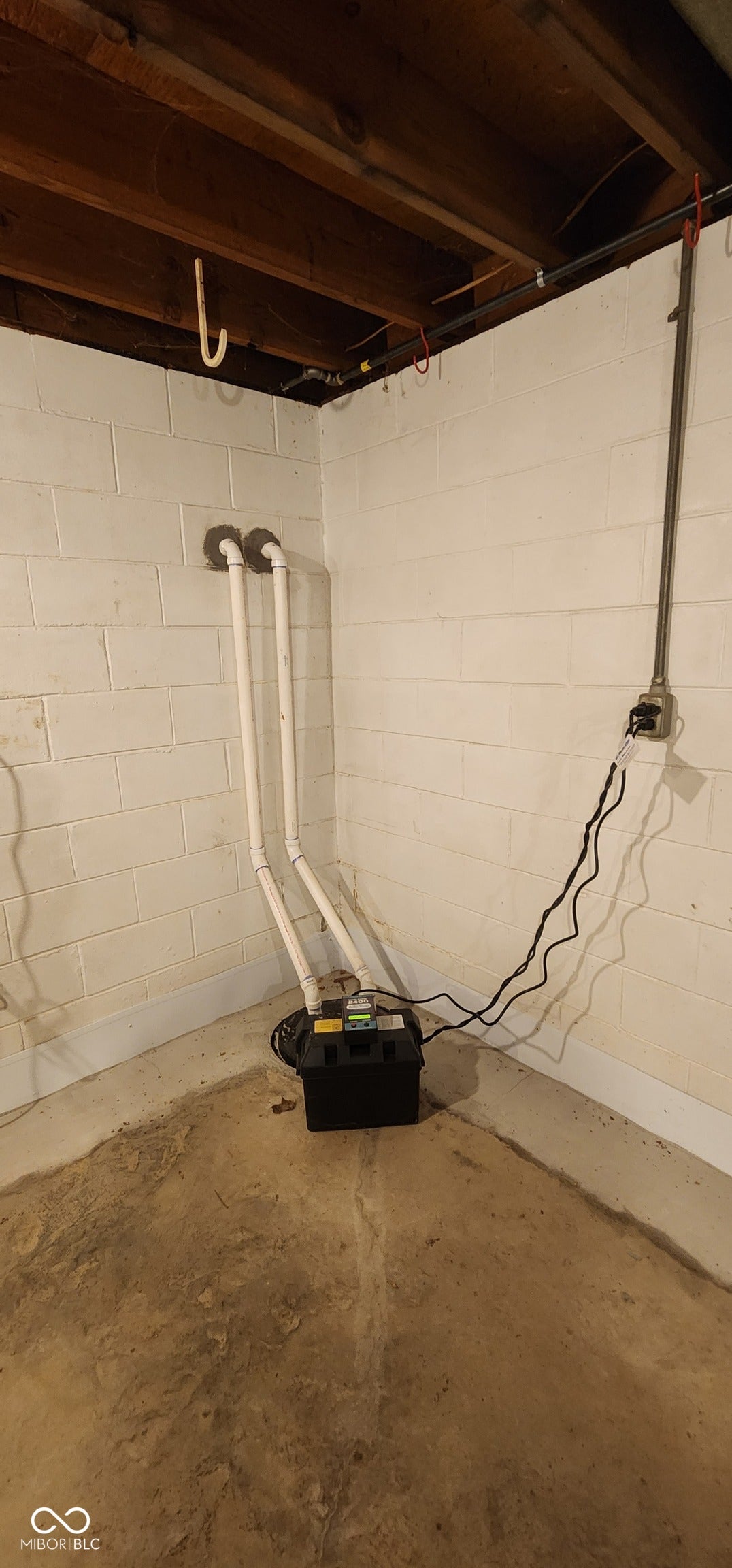 Basement sump pump system with battery backup and alarm.