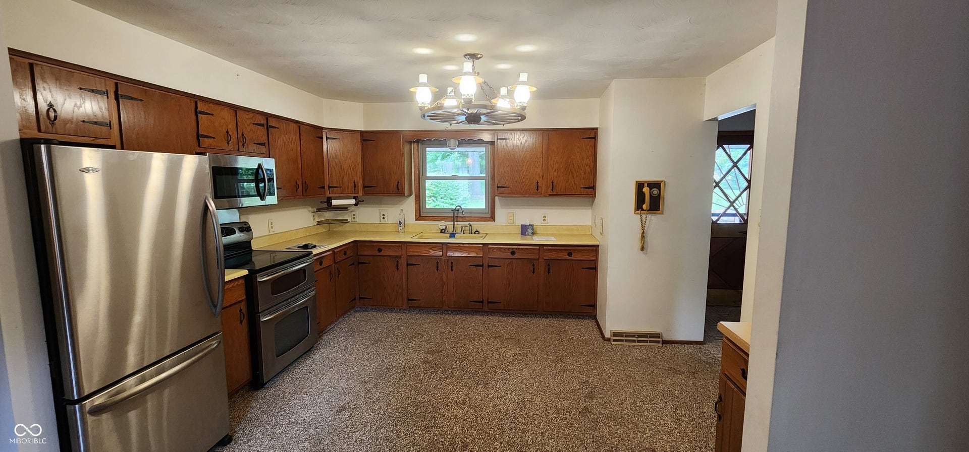 Kitchen featuring extensive wood cabinetry, stainless steel appliances, and a double oven