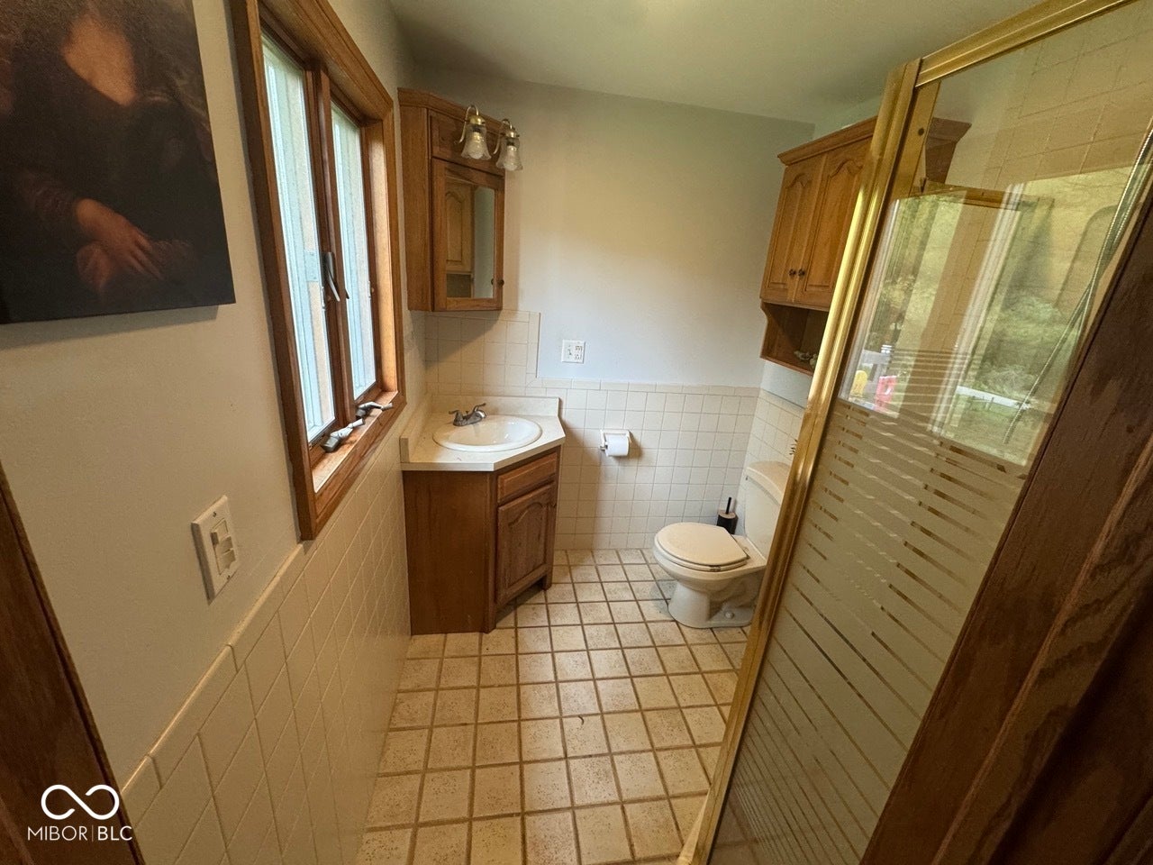 Corner vanity with an integrated sink and wood-finish cabinetry