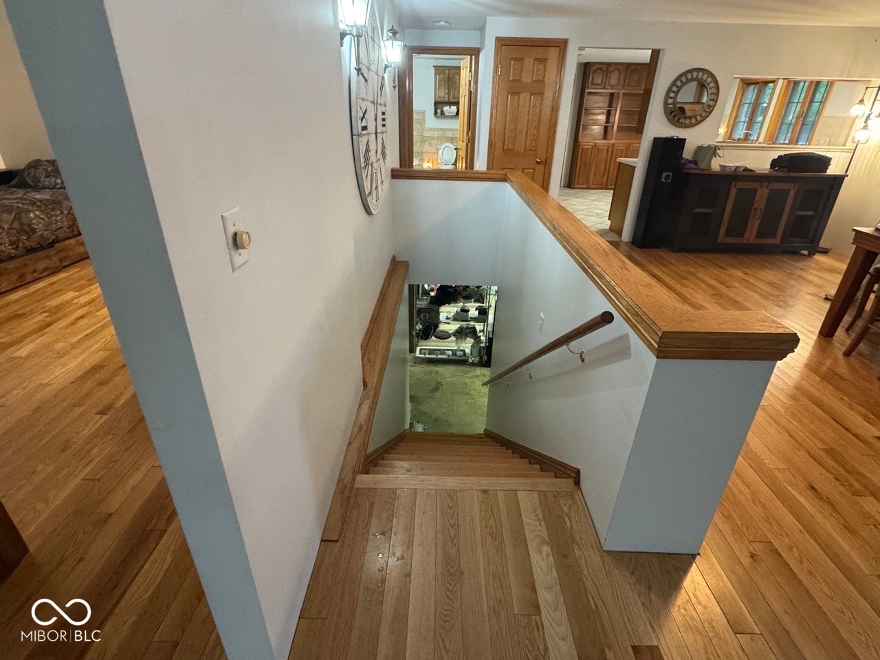 Hardwood flooring throughout, coordinating wood-finish handrails, and solid wood interior doors