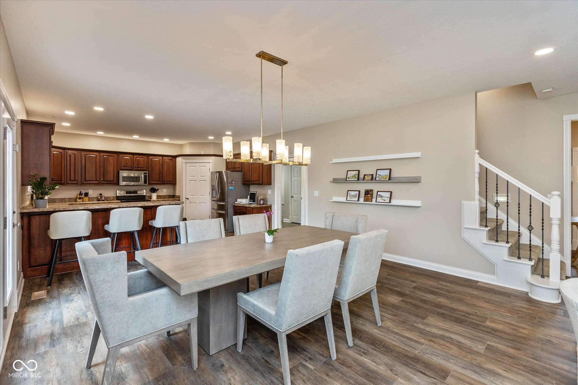 1513 Tottenham, Danville, IN 46122 Wood-finish flooring throughout, with a contemporary linear chandelier over the dining area
