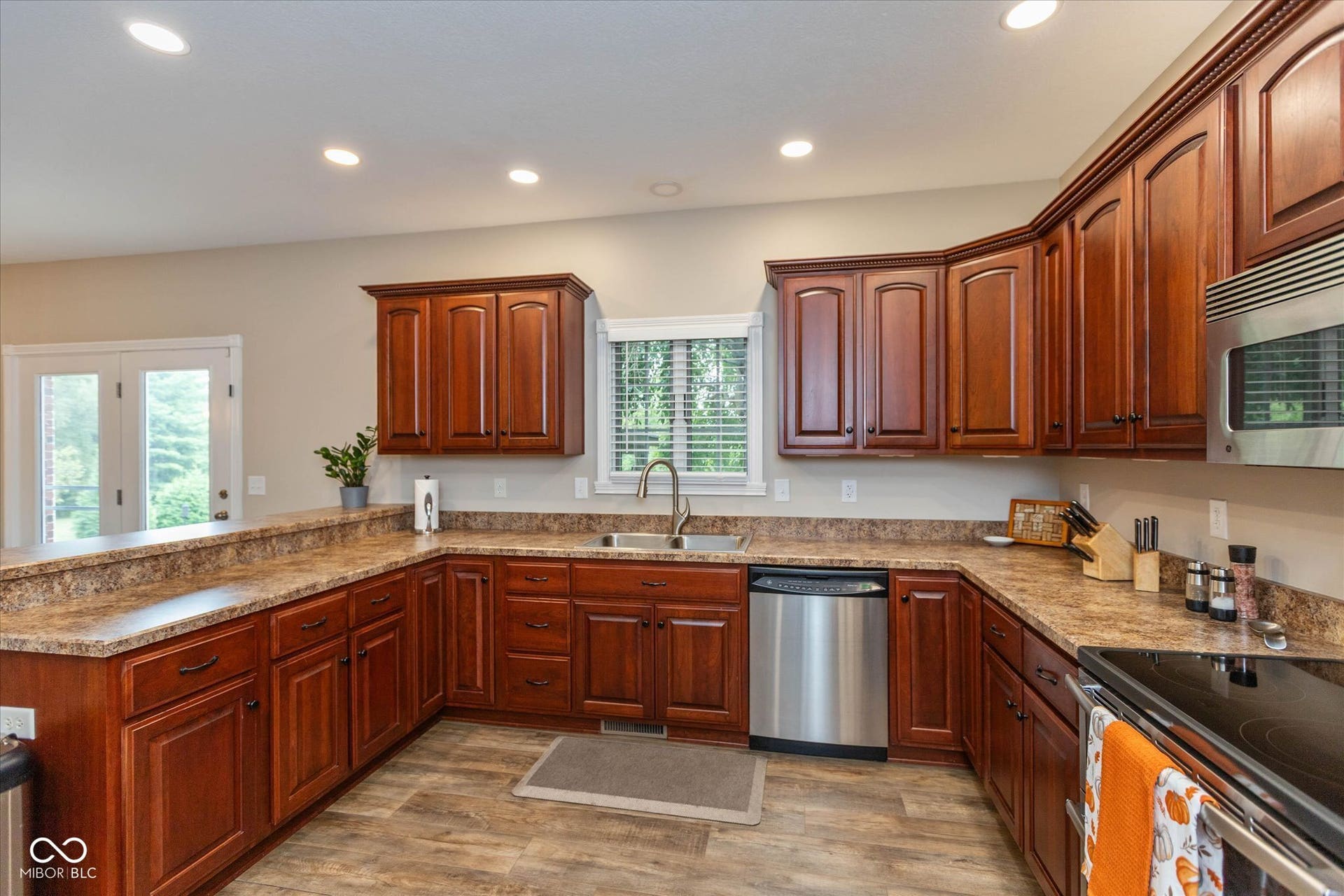 1513 Tottenham, Danville, IN 46122 Wood-finish flooring, ample wood cabinetry, stainless steel appliances, recessed ceiling lighting, and a double patio door