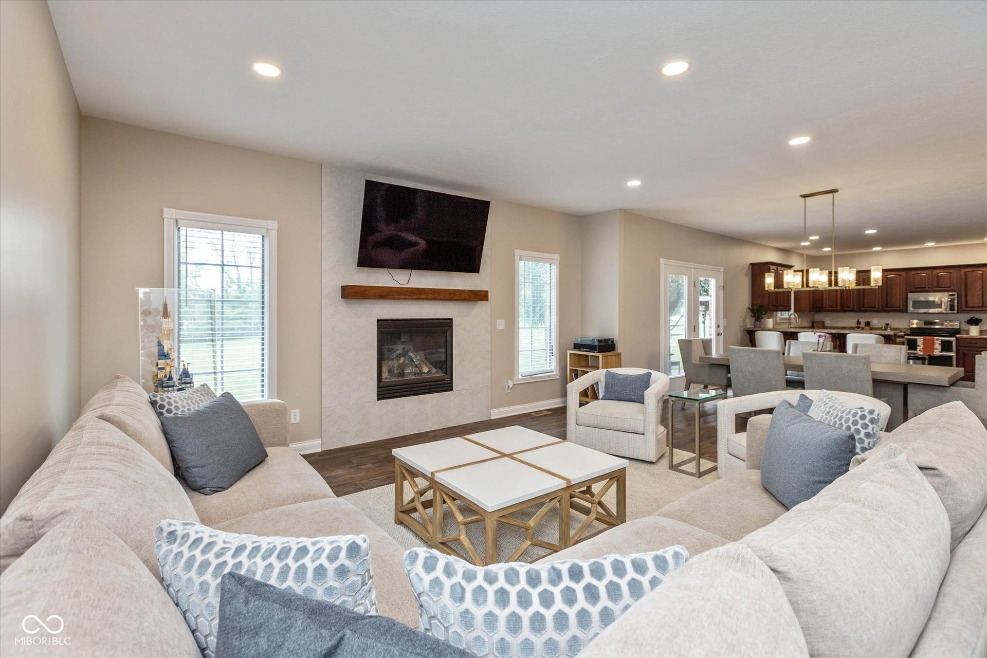 1513 Tottenham, Danville, IN 46122 Recessed lighting illuminates the living area with a fireplace featuring a wood mantel