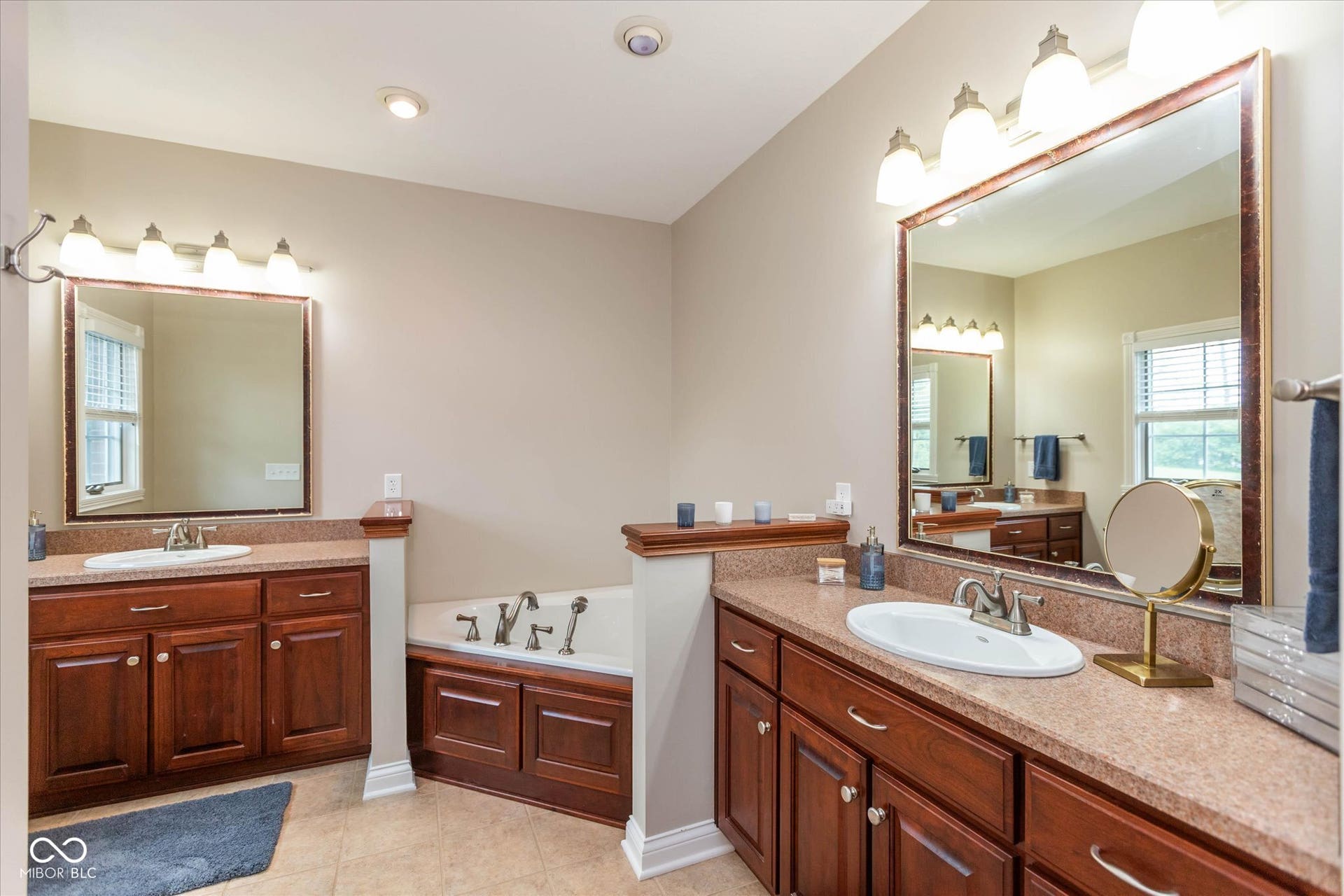 1513 Tottenham, Danville, IN 46122 Dual vanity sinks with wood-finish cabinetry, a built-in soaking tub, framed mirrors, and recessed ceiling lighting