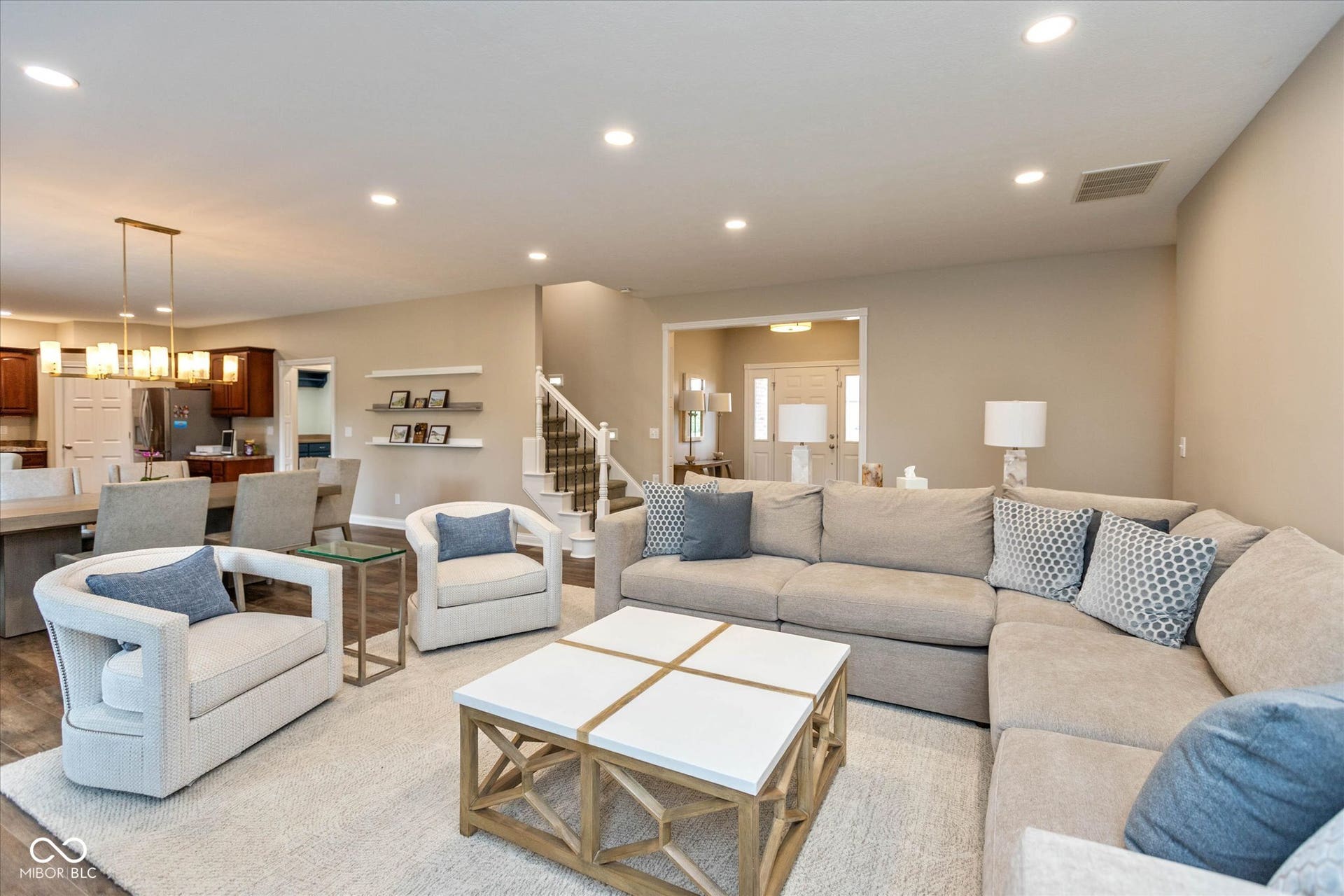 1513 Tottenham, Danville, IN 46122 Recessed lighting, wood-finish flooring, staircase with carpeted treads, floating shelves, and an open concept layout