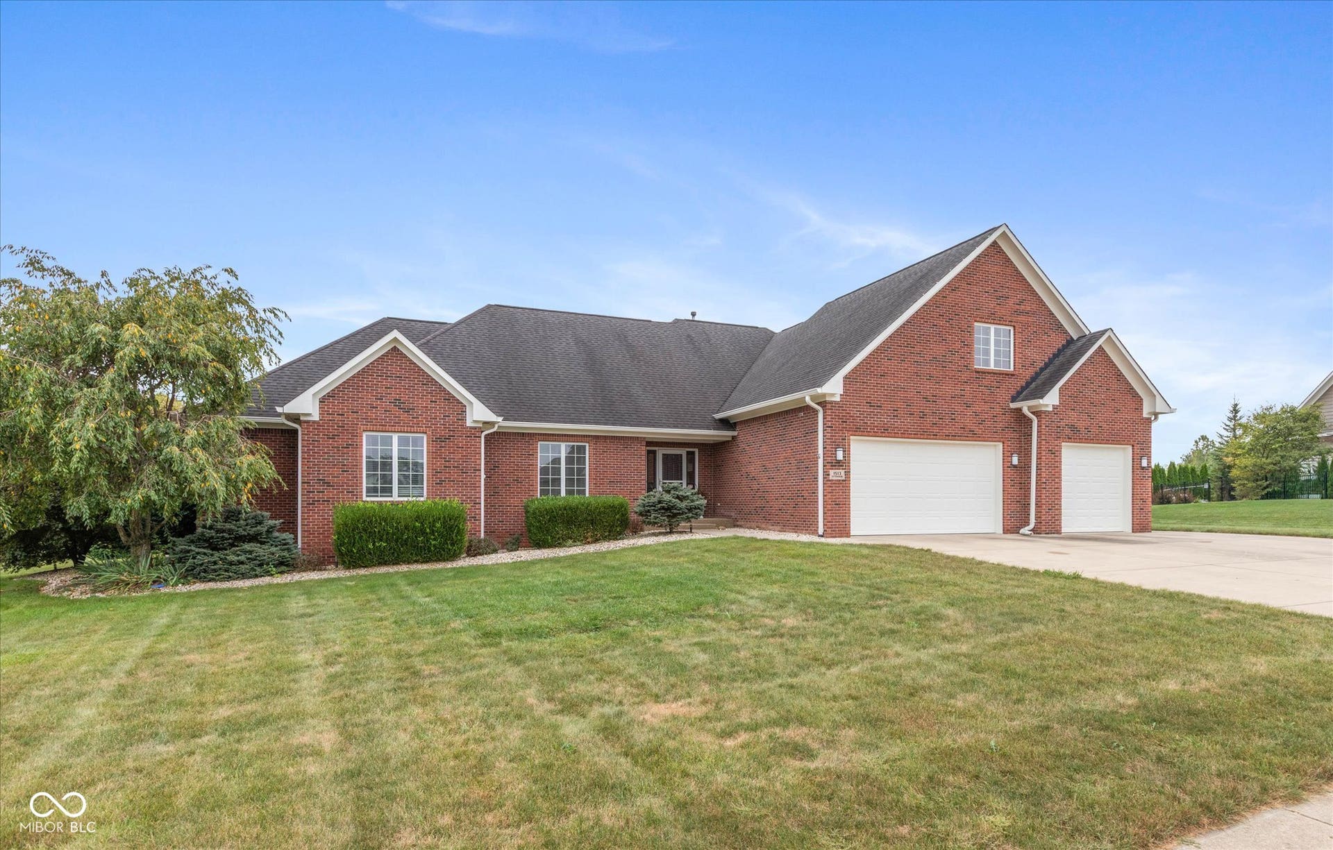 1513 Tottenham, Danville, IN 46122 Brick-clad residence featuring a multi-car garage, pitched roofline, and established landscaping