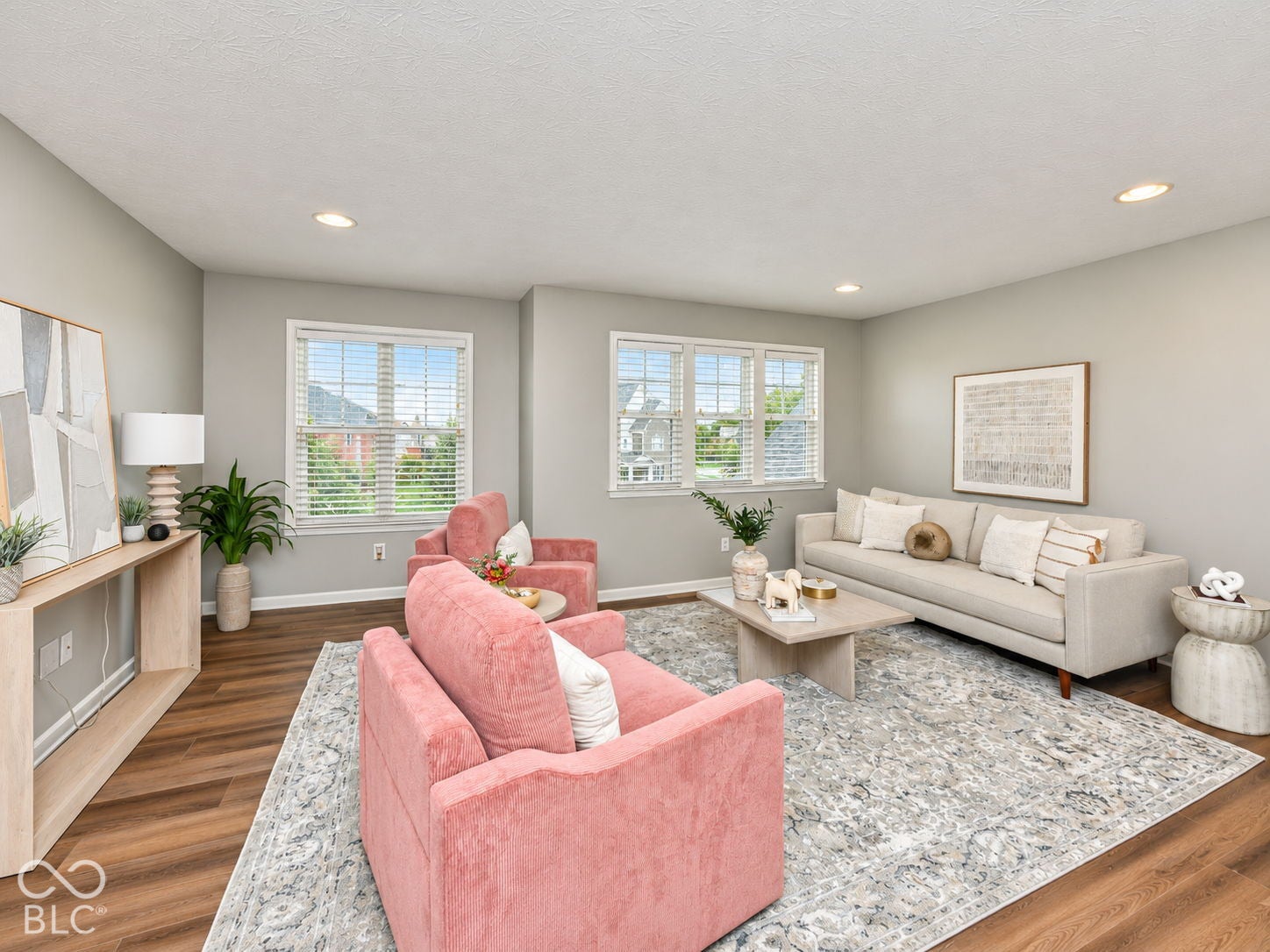 Wood-finish flooring, recessed lighting, multiple windows, and light gray wall paint