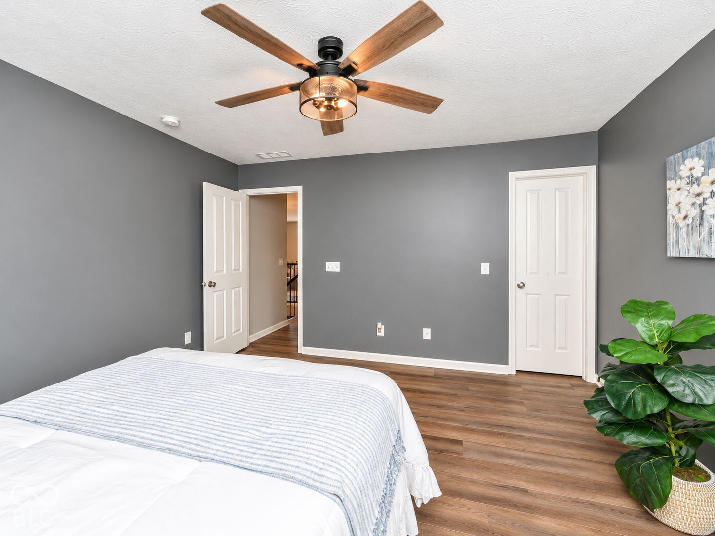 Hardwood-style flooring and a ceiling fan with integrated lighting