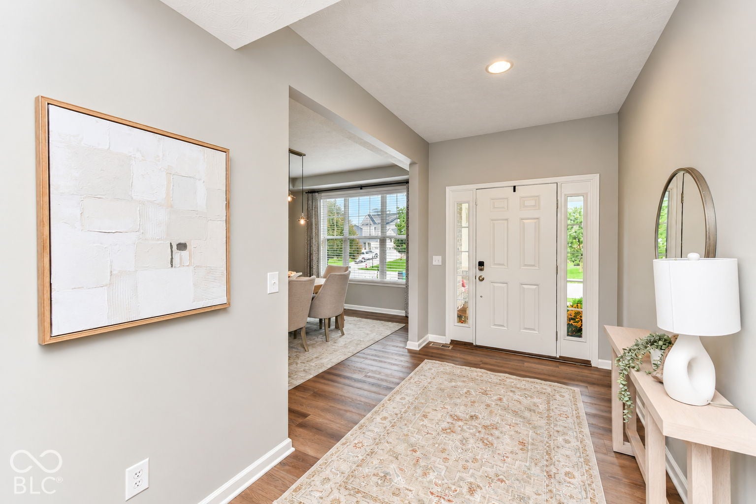 Foyer featuring wood-finish flooring, recessed lighting, and a paneled entry door with sidelights
