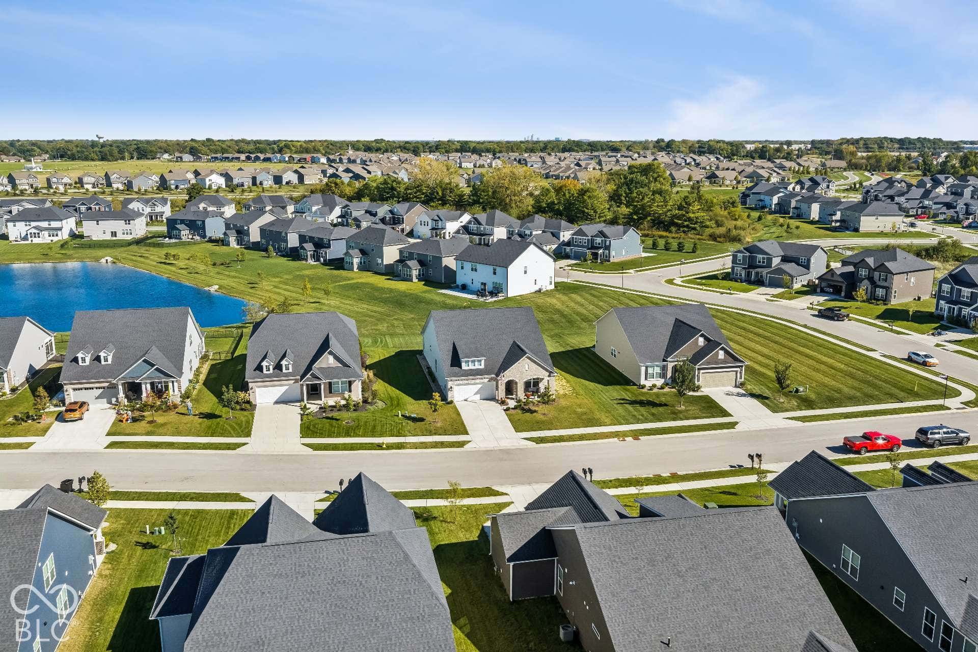 Expansive neighborhood featuring residential properties, paved streets, and manicured lawns