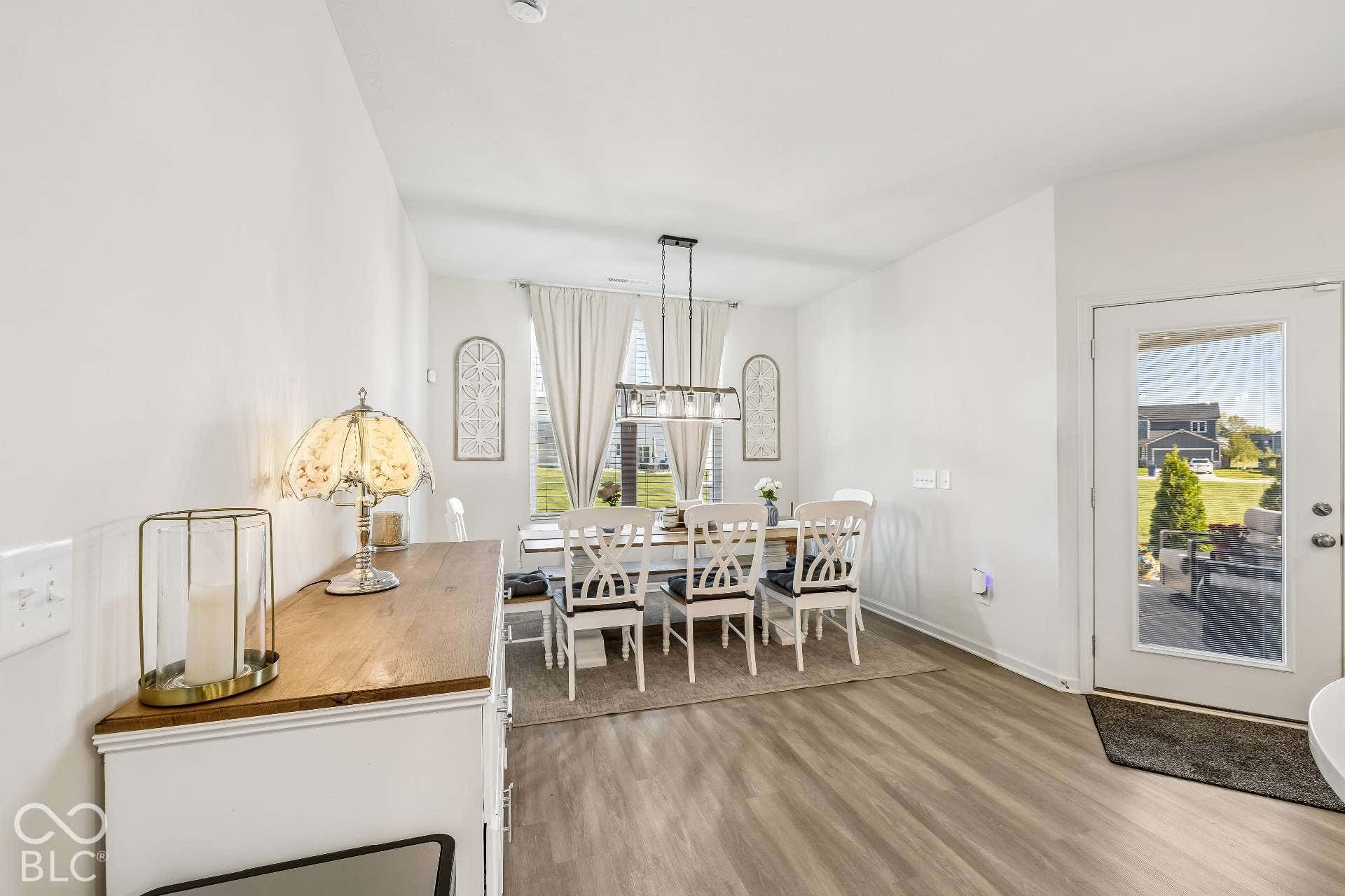 Light wood-finish flooring, white walls, and a glass-paneled door