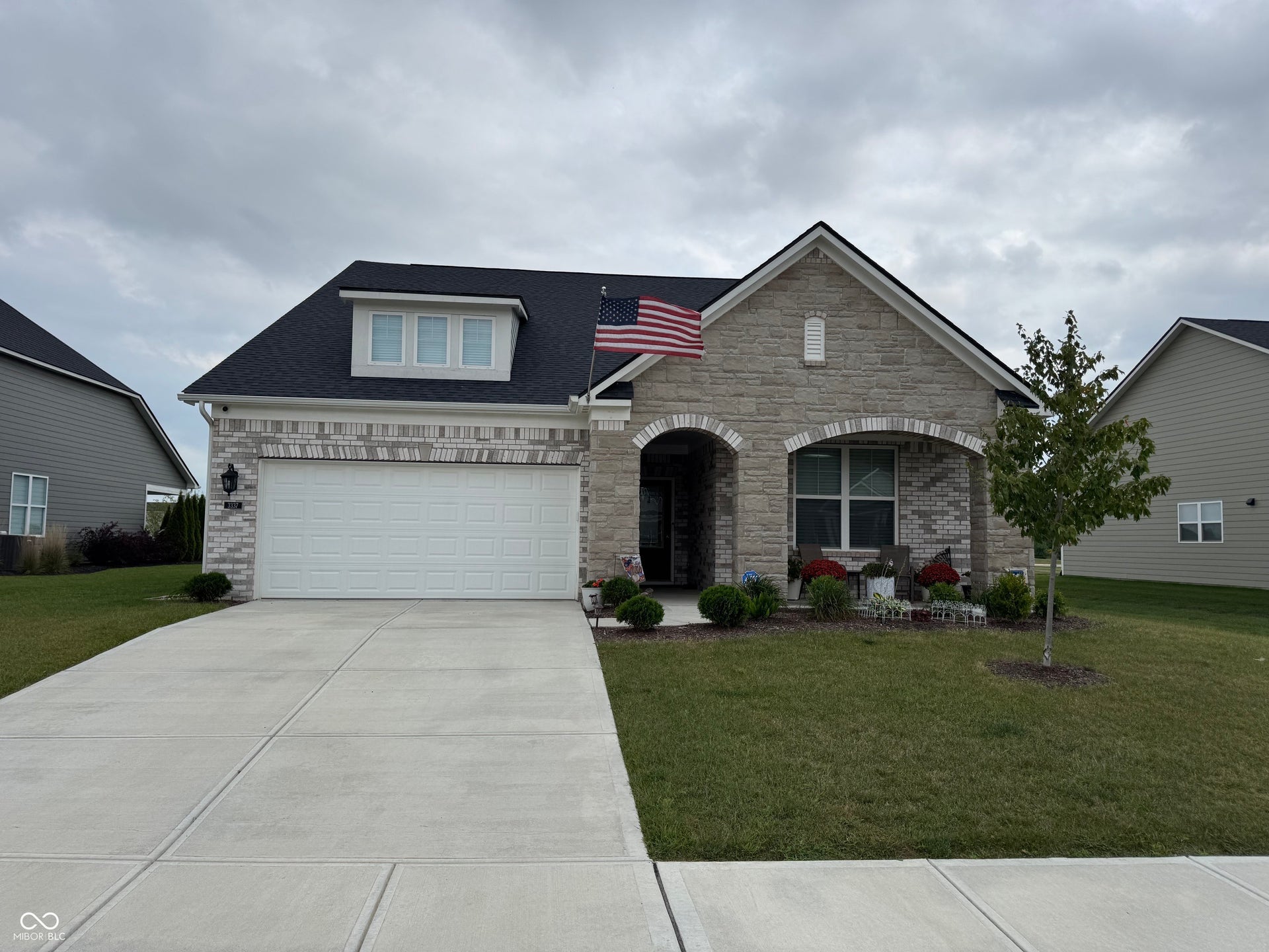 Stone and brick veneer exterior with a covered entry
