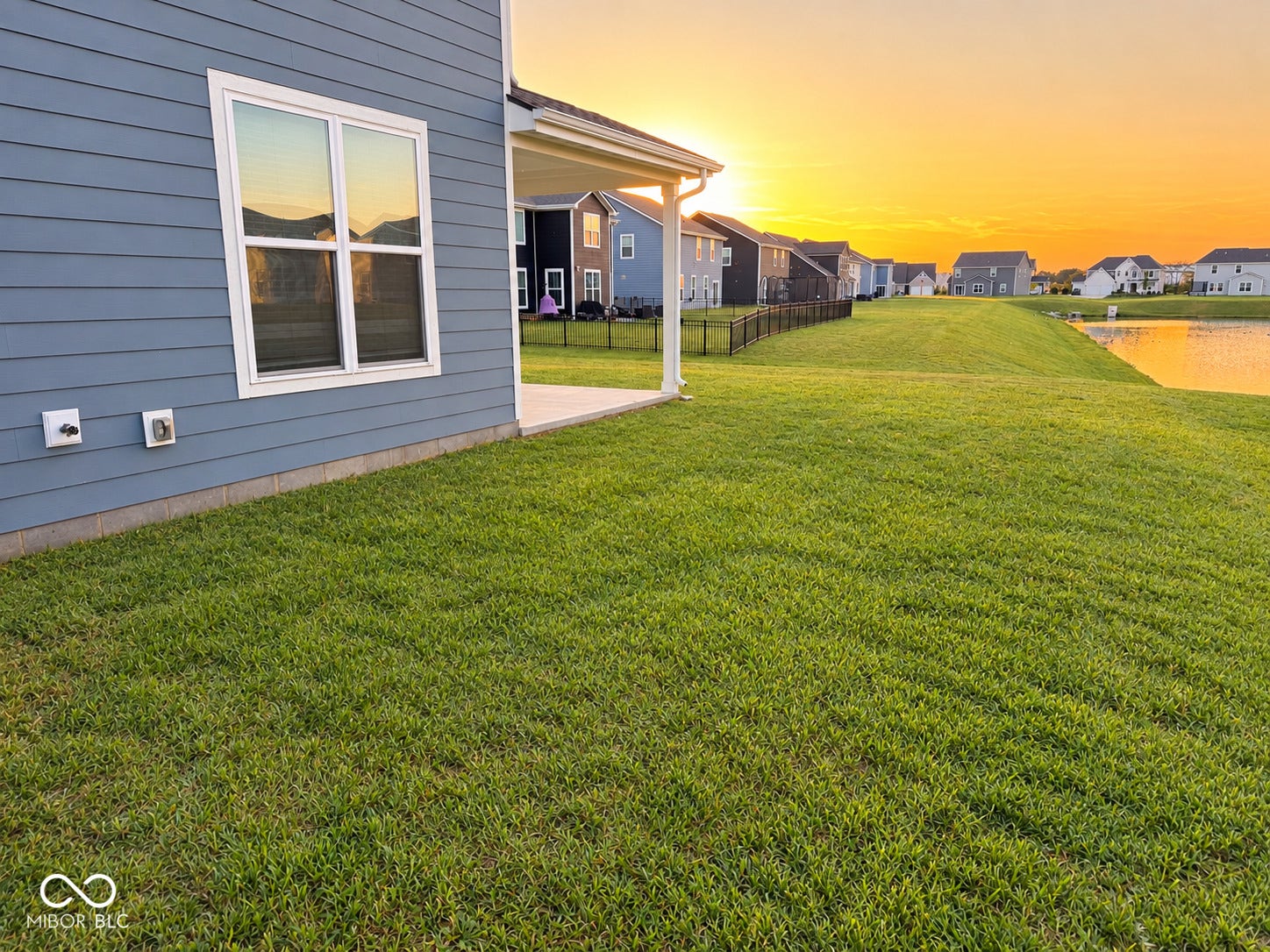 6008 Phillips Drive, Brownsburg, IN 46112 Expansive lawn featuring a concrete patio and waterfront view.