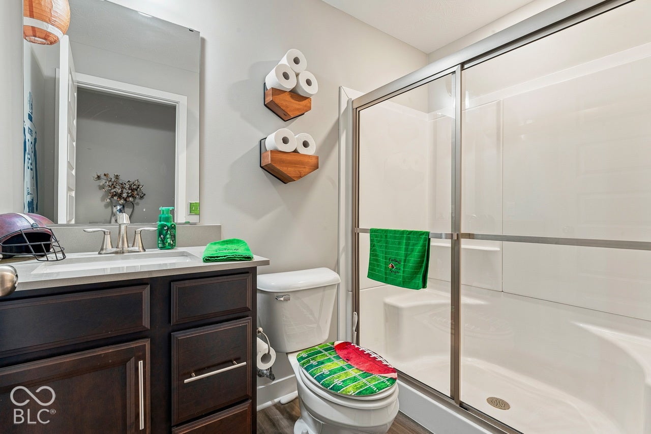 Dark wood-finish vanity with drawer storage and brushed nickel hardware