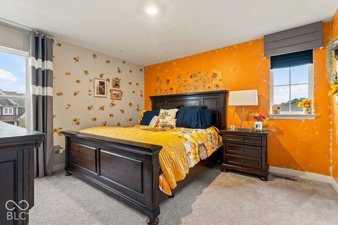 Carpeted flooring, window with blind, recessed ceiling light, and painted walls
