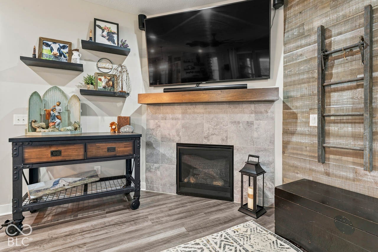 Built-in fireplace with tile surround, wood mantel, and integrated shelving