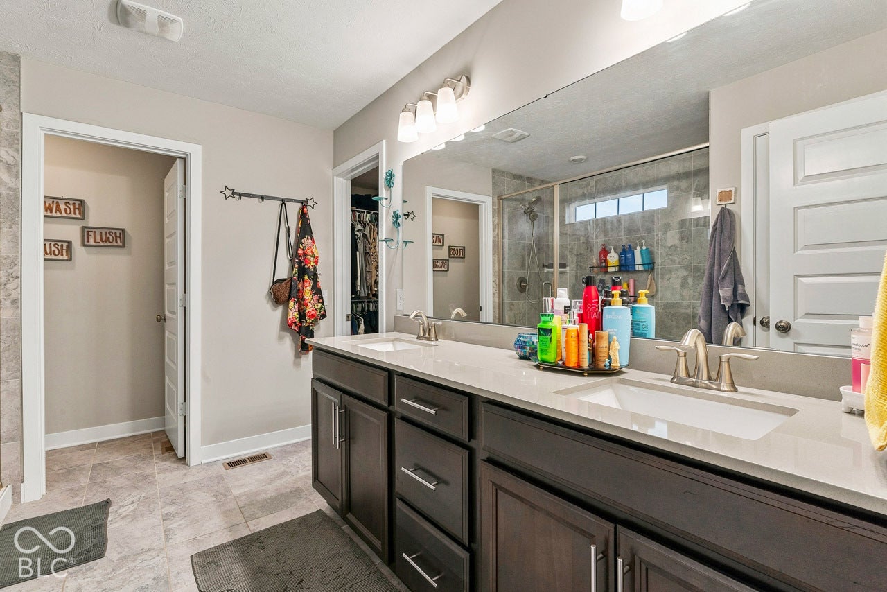 Double vanity with integrated sinks, brushed nickel fixtures, and a light-toned countertop