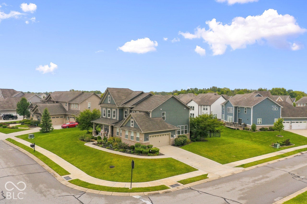 Two-story residence with a covered front porch, attached garage, and a steeply pitched roof