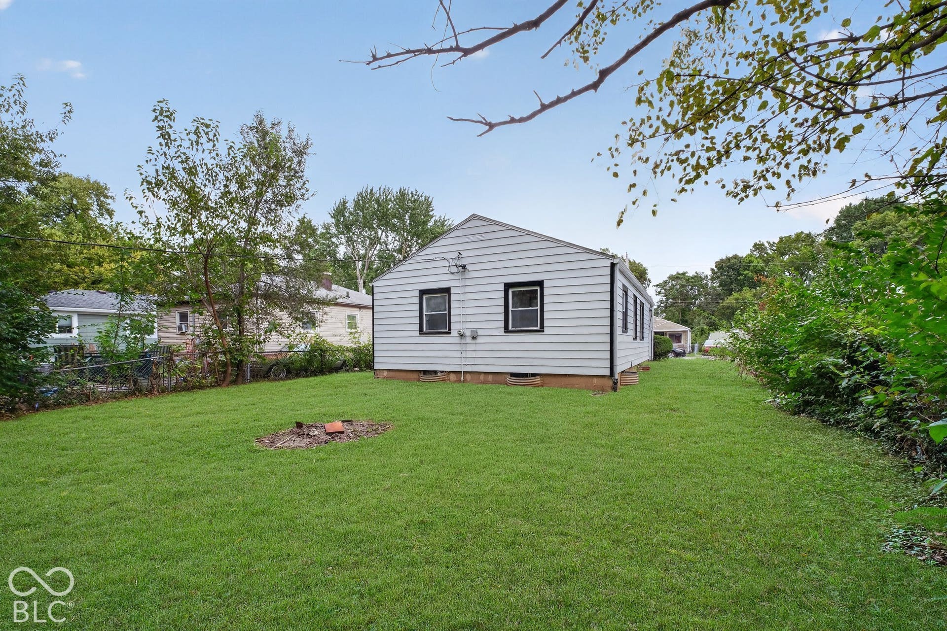 Expansive lawn area with mature trees and established greenery